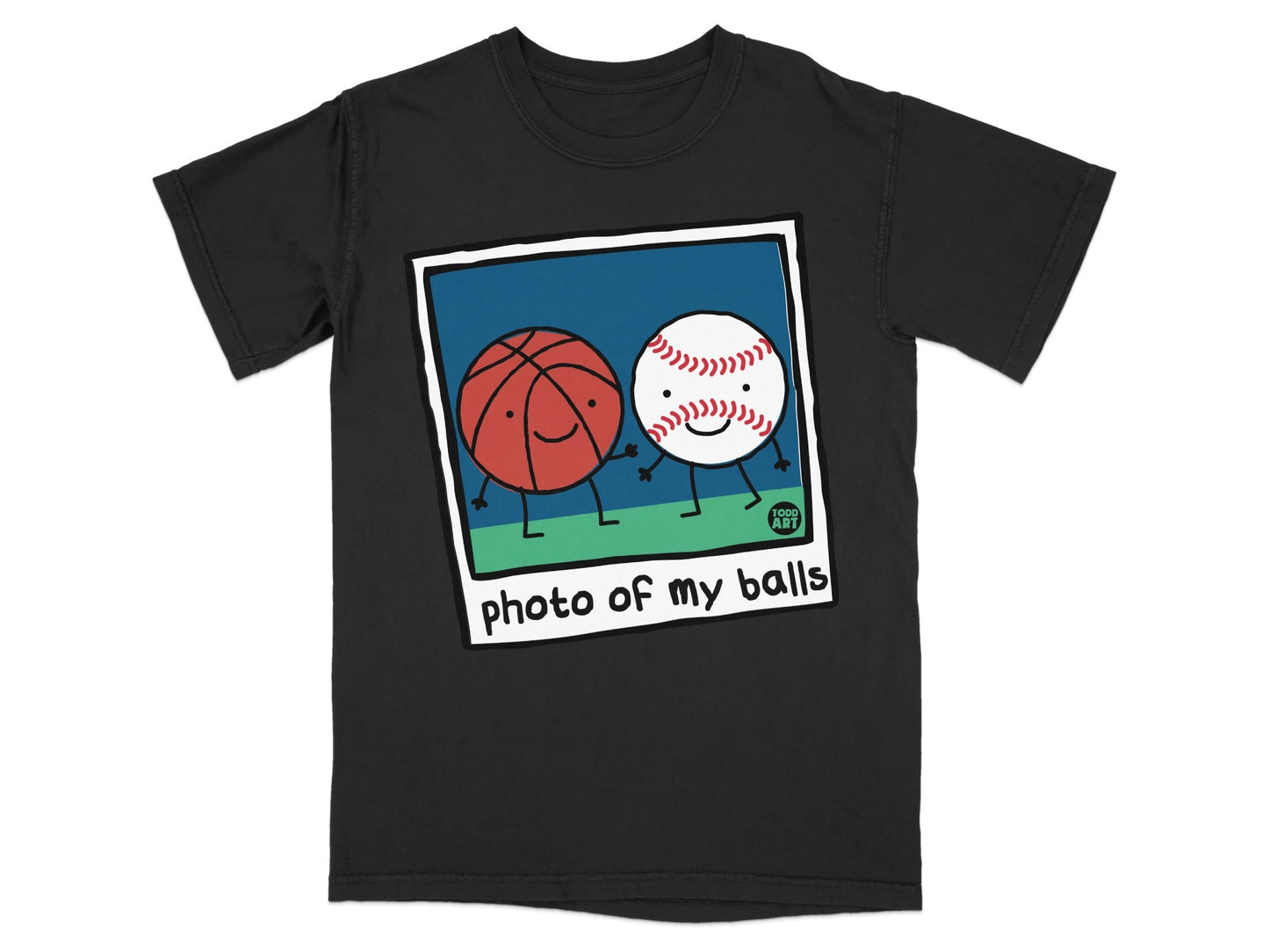 T-shirt featuring a cartoon polaroid of two smiling sports balls: a basketball and a baseball.