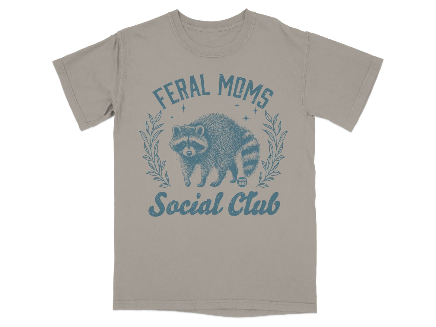 Feral Moms Social Club graphic on a taupe t-shirt with raccoon and laurel wreath.