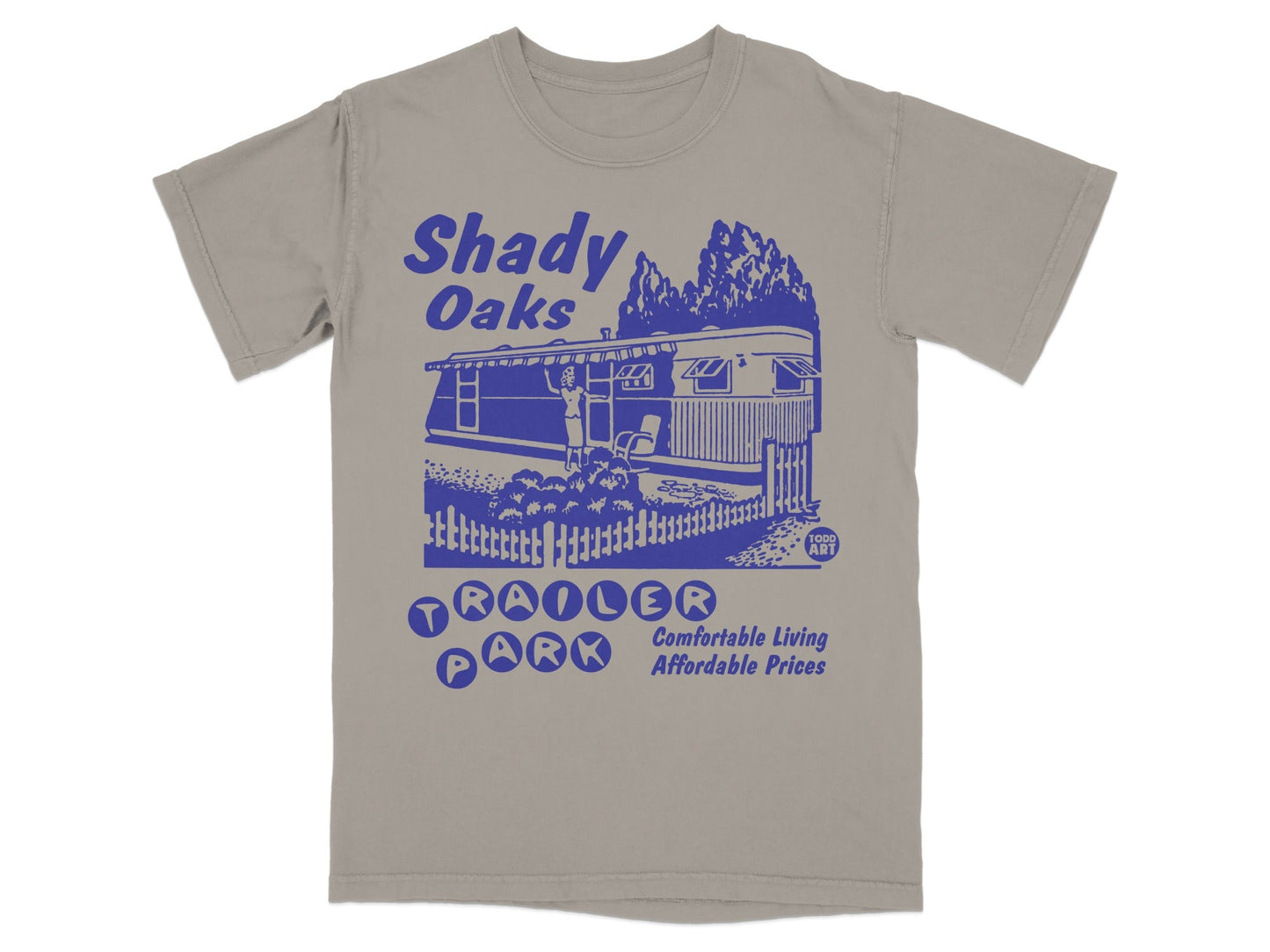 Shady Oaks Trailer Park blue graphic on tan t-shirt.