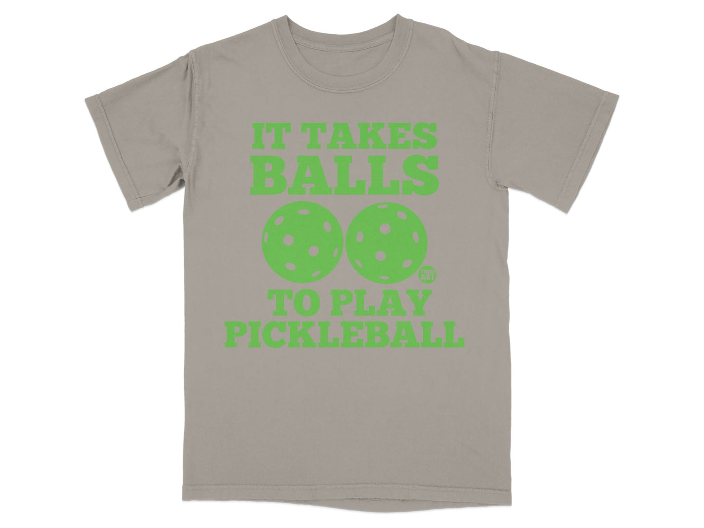 T-shirt with green text and pickleball graphics: "IT TAKES BALLS TO PLAY PICKLEBALL".