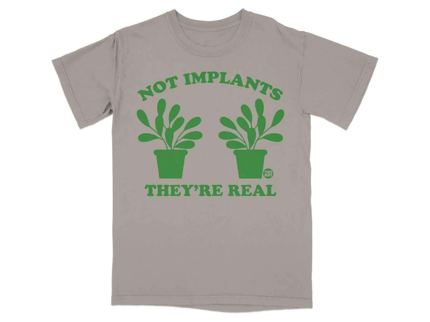 T-shirt with green plants and text: "NOT IMPLANTS THEY'RE REAL".