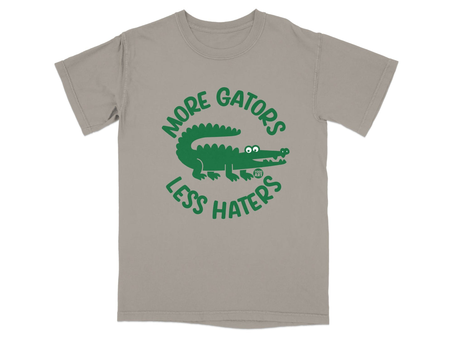 Green alligator graphic on a taupe t-shirt with text "MORE GATORS LESS HATERS".