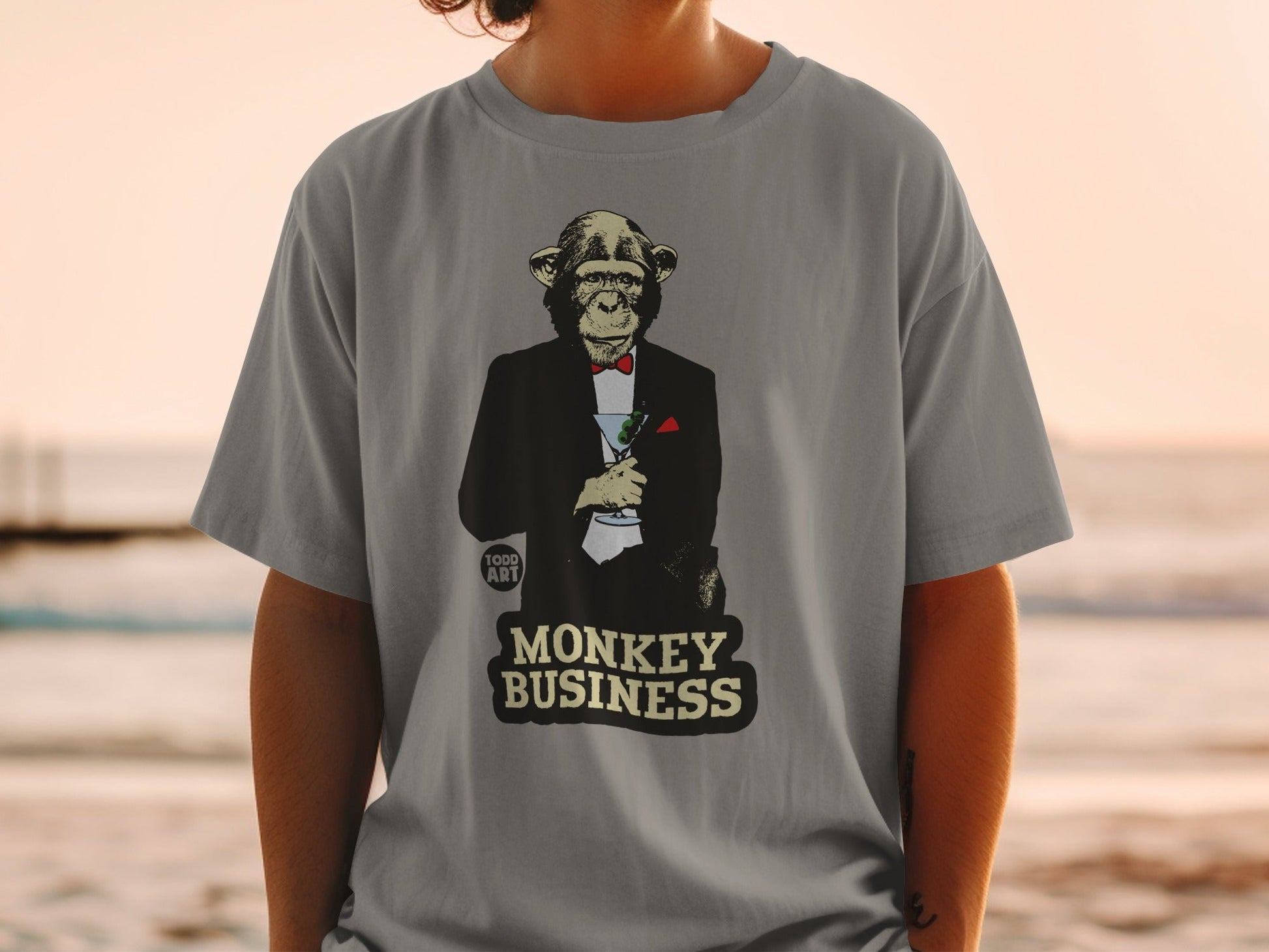 Monkey in a tuxedo holding a martini, "MONKEY BUSINESS" text.