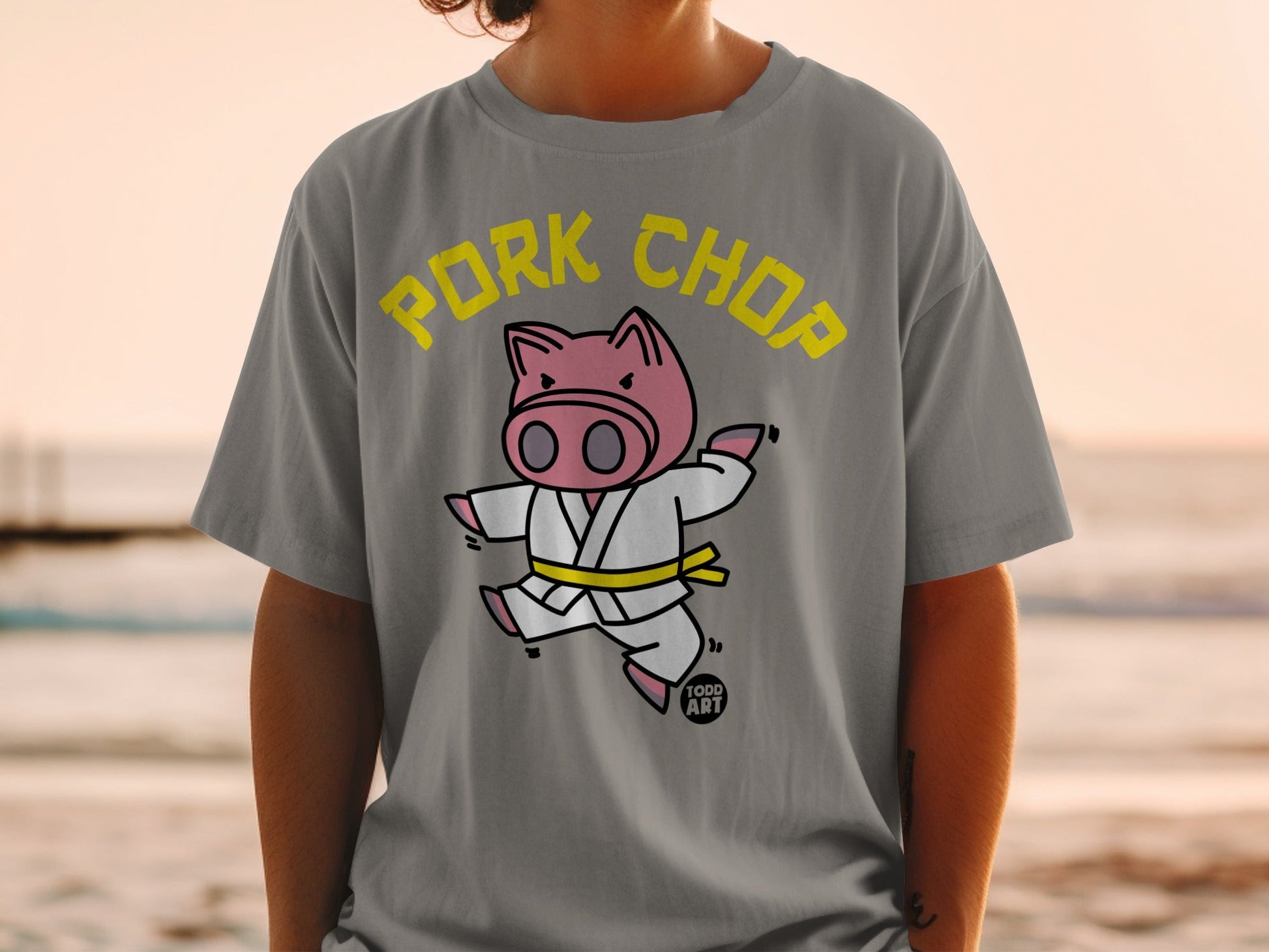 Karate pig wearing a white gi and yellow belt, "PORK CHOP" text.