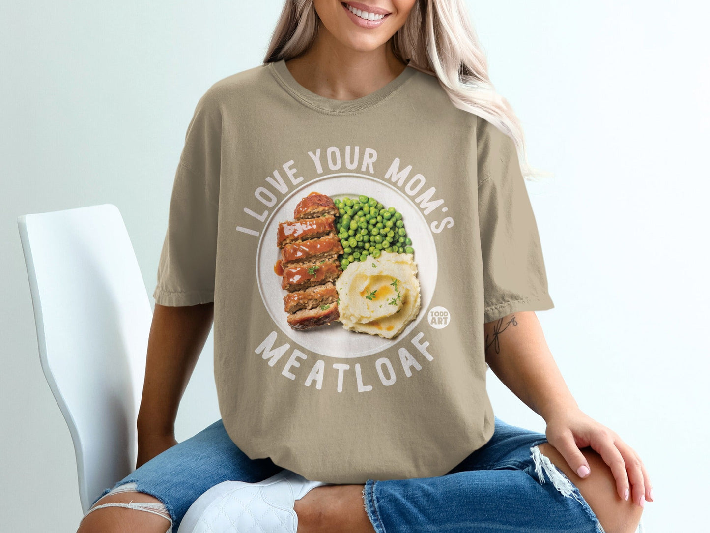 T-shirt featuring a graphic of meatloaf, mashed potatoes, and peas.