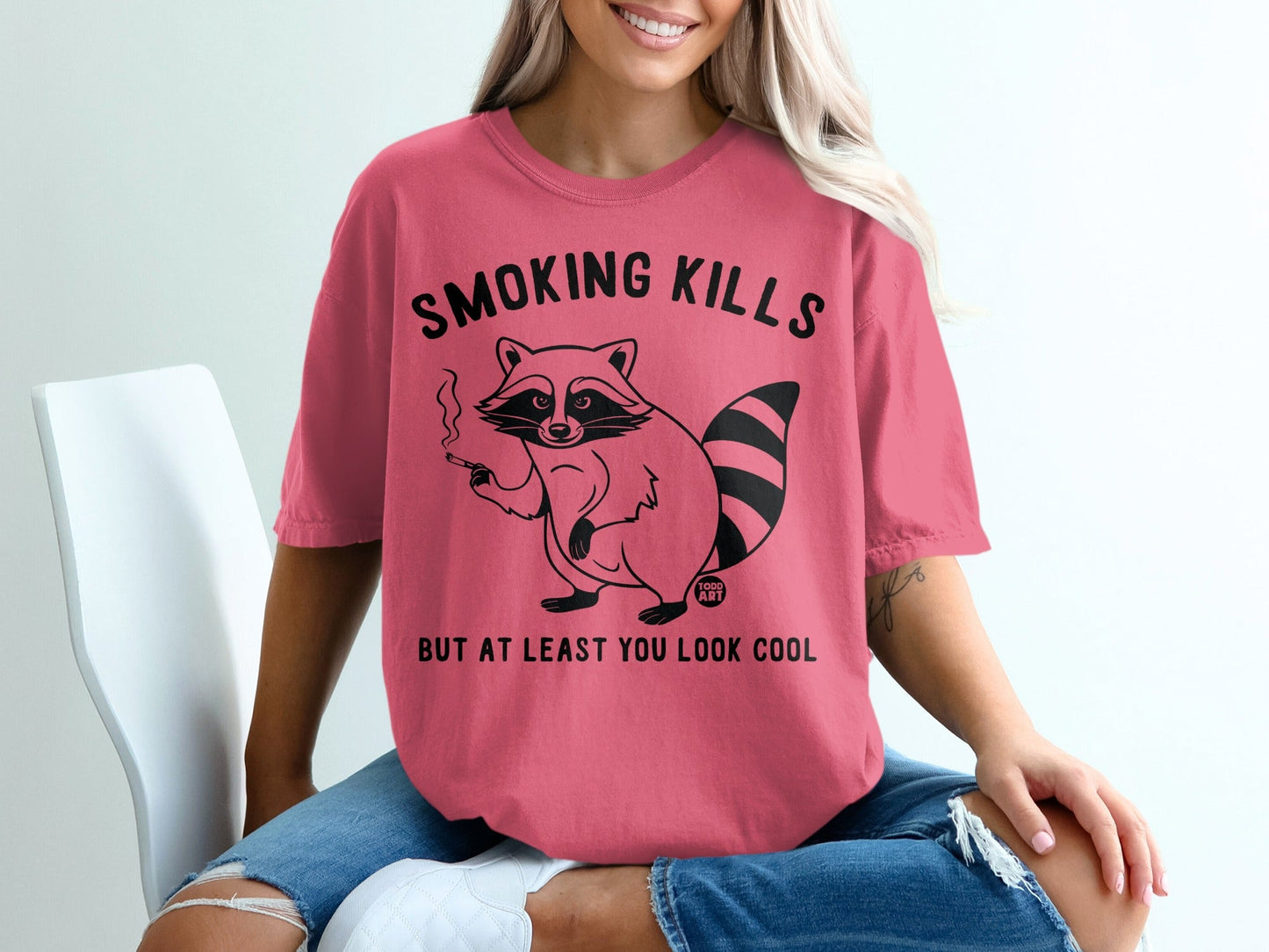 T-shirt with raccoon smoking and text "Smoking Kills But At Least You Look Cool".