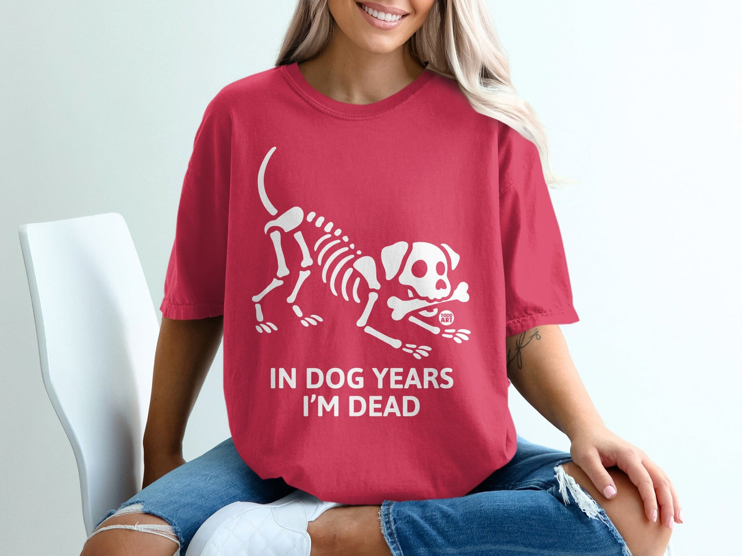Red t-shirt with a white dog skeleton graphic and text "IN DOG YEARS I'M DEAD".
