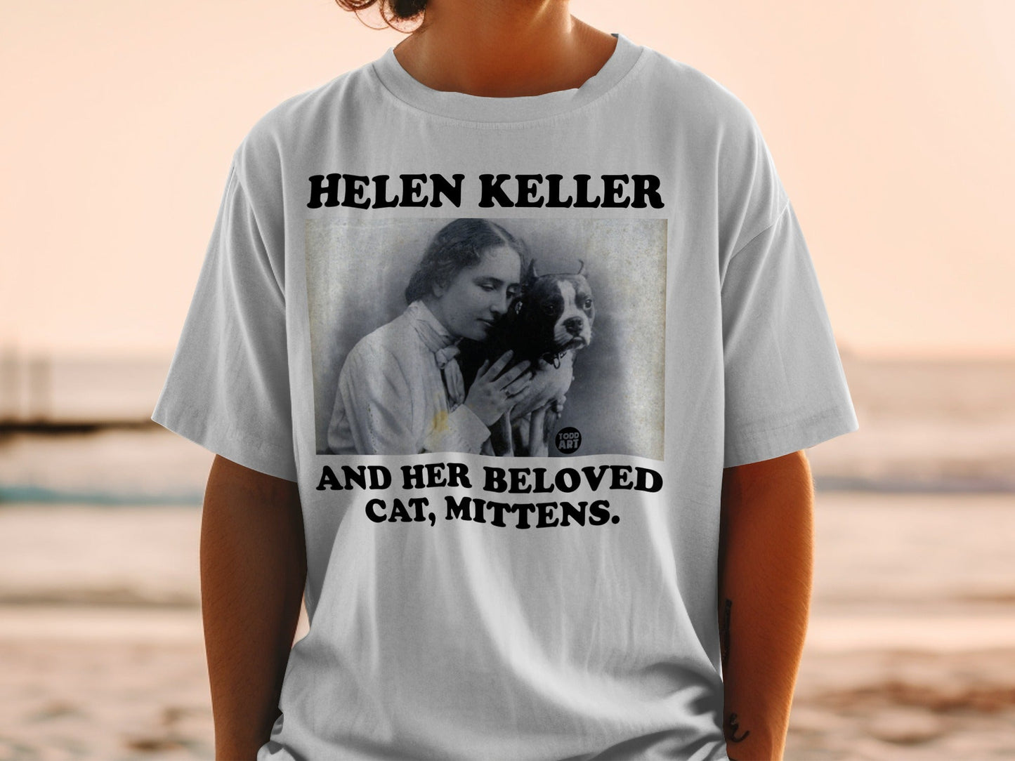 Helen Keller and cat graphic on white t-shirt.
