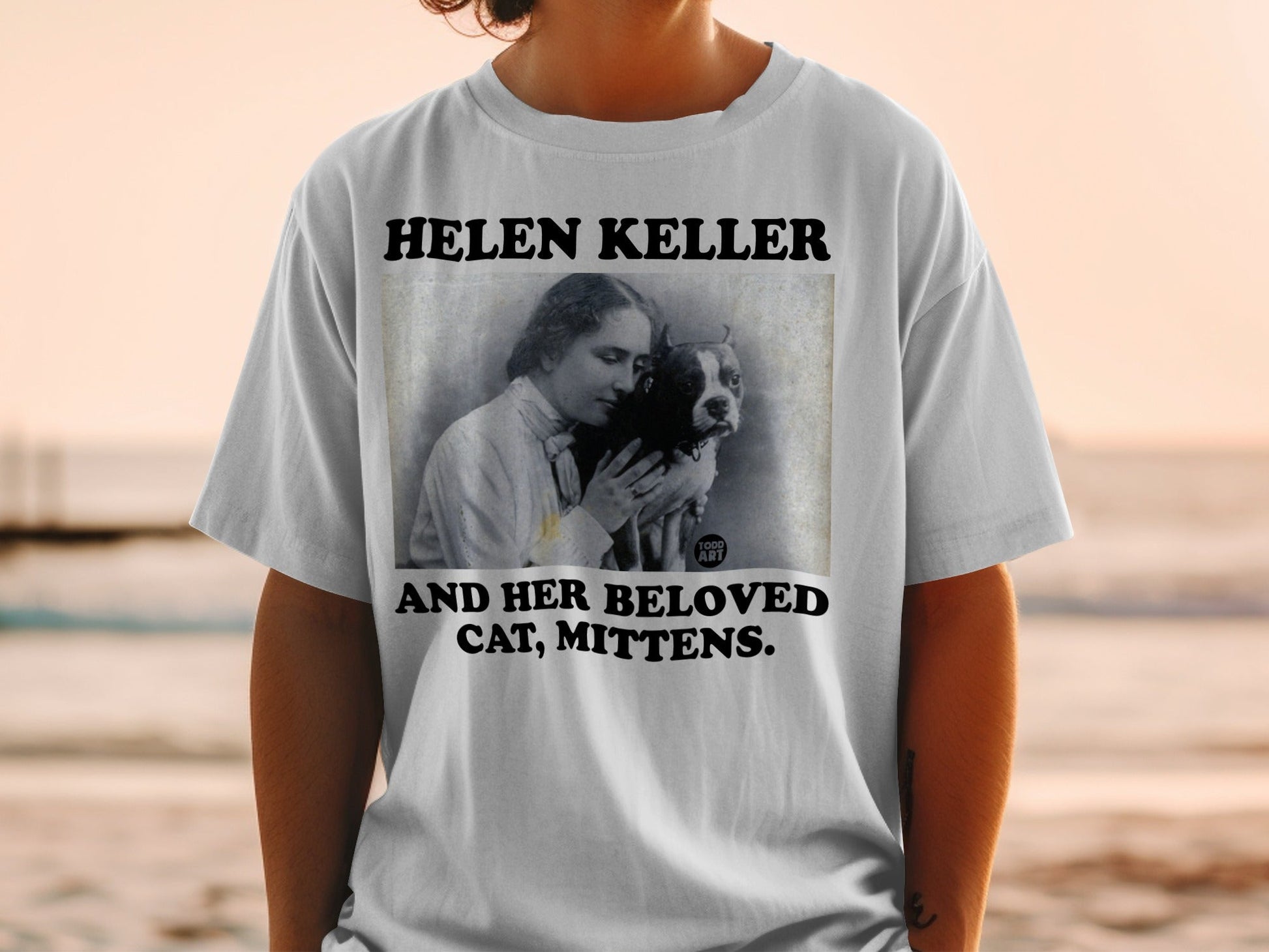 Helen Keller and cat graphic on white t-shirt.