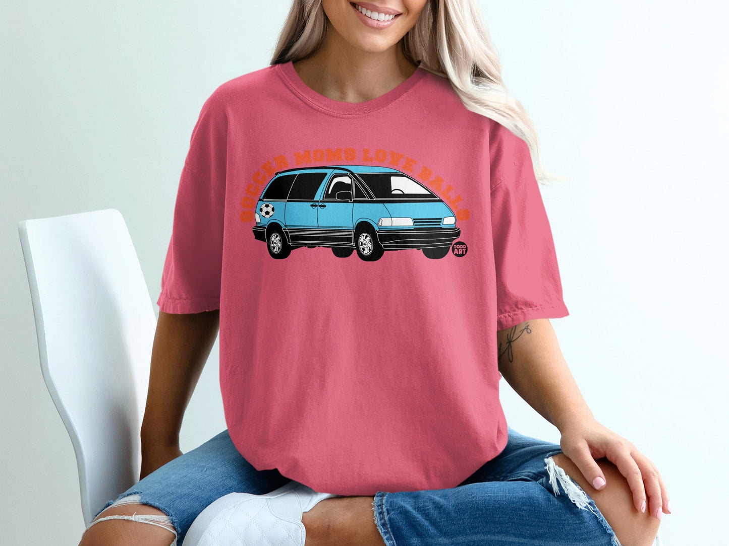 Pink t-shirt with a blue minivan and text "Soccer Moms Love Balls".