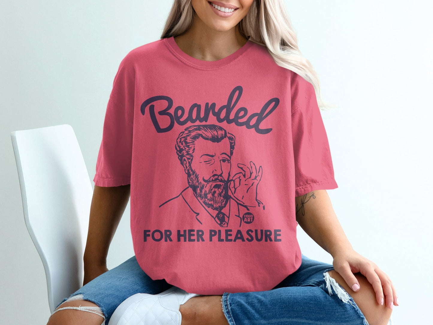 Coral t-shirt with "Bearded for Her Pleasure" text and a man's illustration.