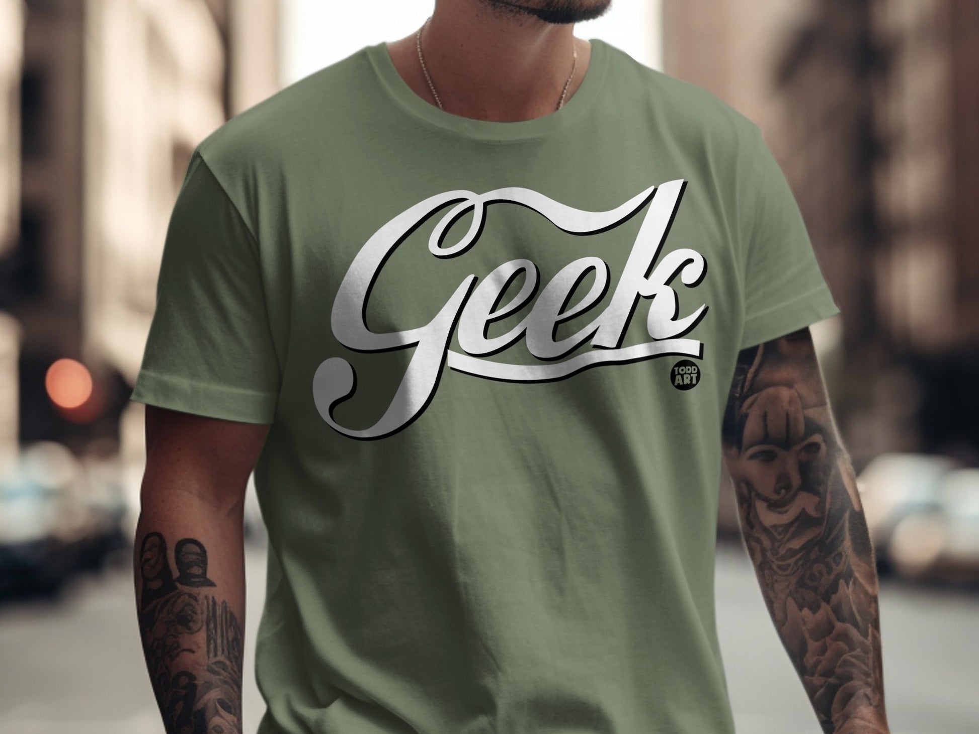Green t-shirt with "Geek" logo and tattoo sleeves.