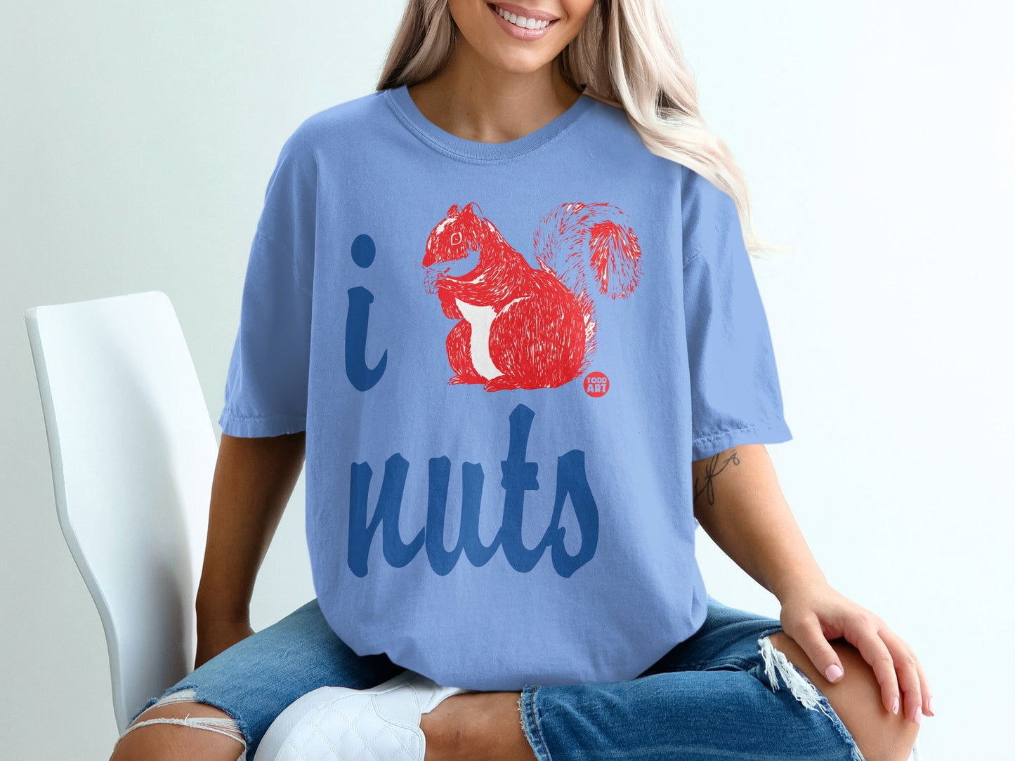 Light blue t-shirt with red squirrel and "I nuts" text graphic.