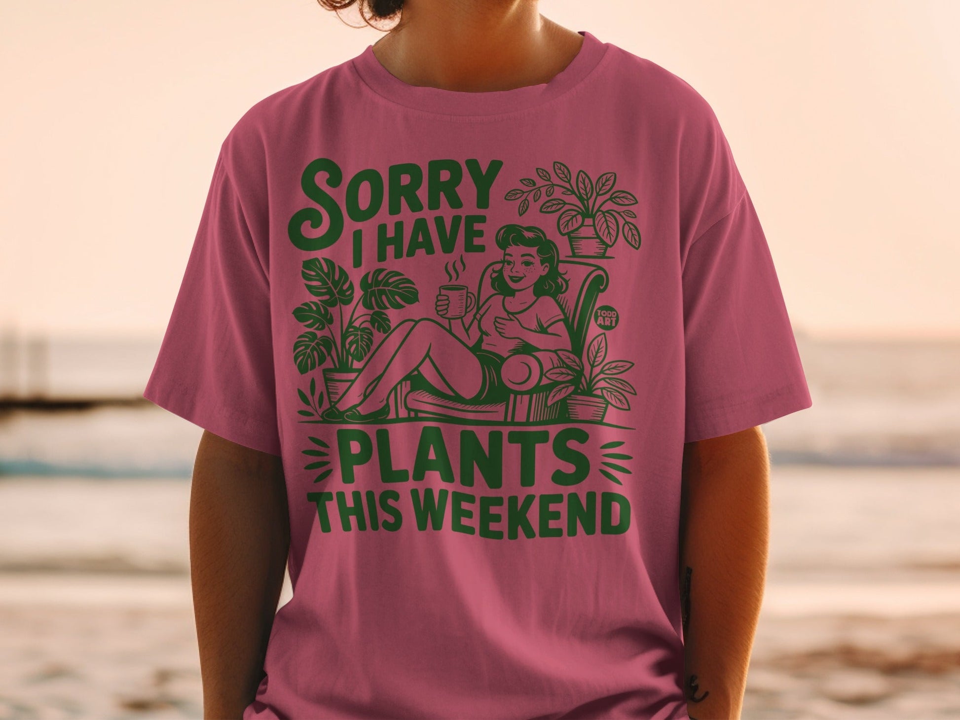 Pink t-shirt with "Sorry I Have Plants This Weekend" graphic.