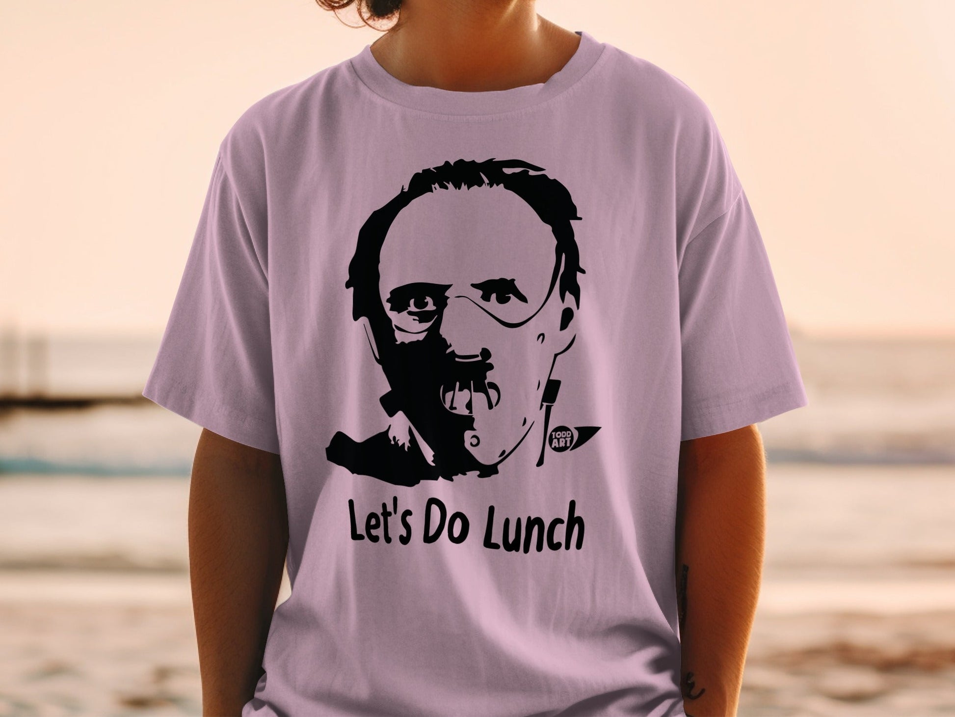 Purple t-shirt with Hannibal Lecter graphic and "Let's Do Lunch" text.