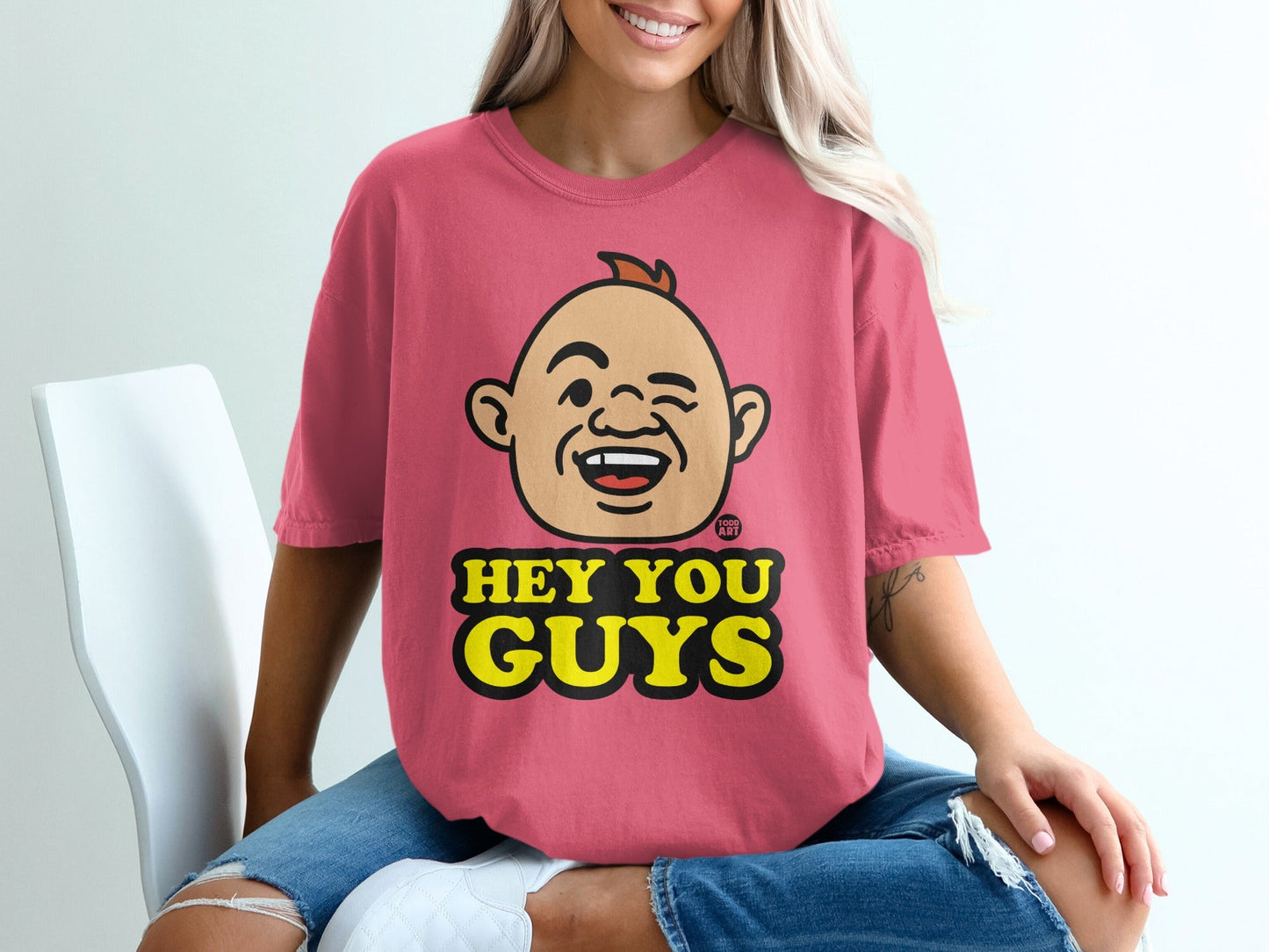Pink t-shirt with a cartoon character and "HEY YOU GUYS" text.