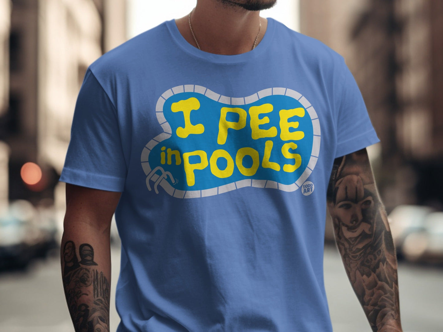 Blue t-shirt with "I PEE IN POOLS" text in yellow pool shape.