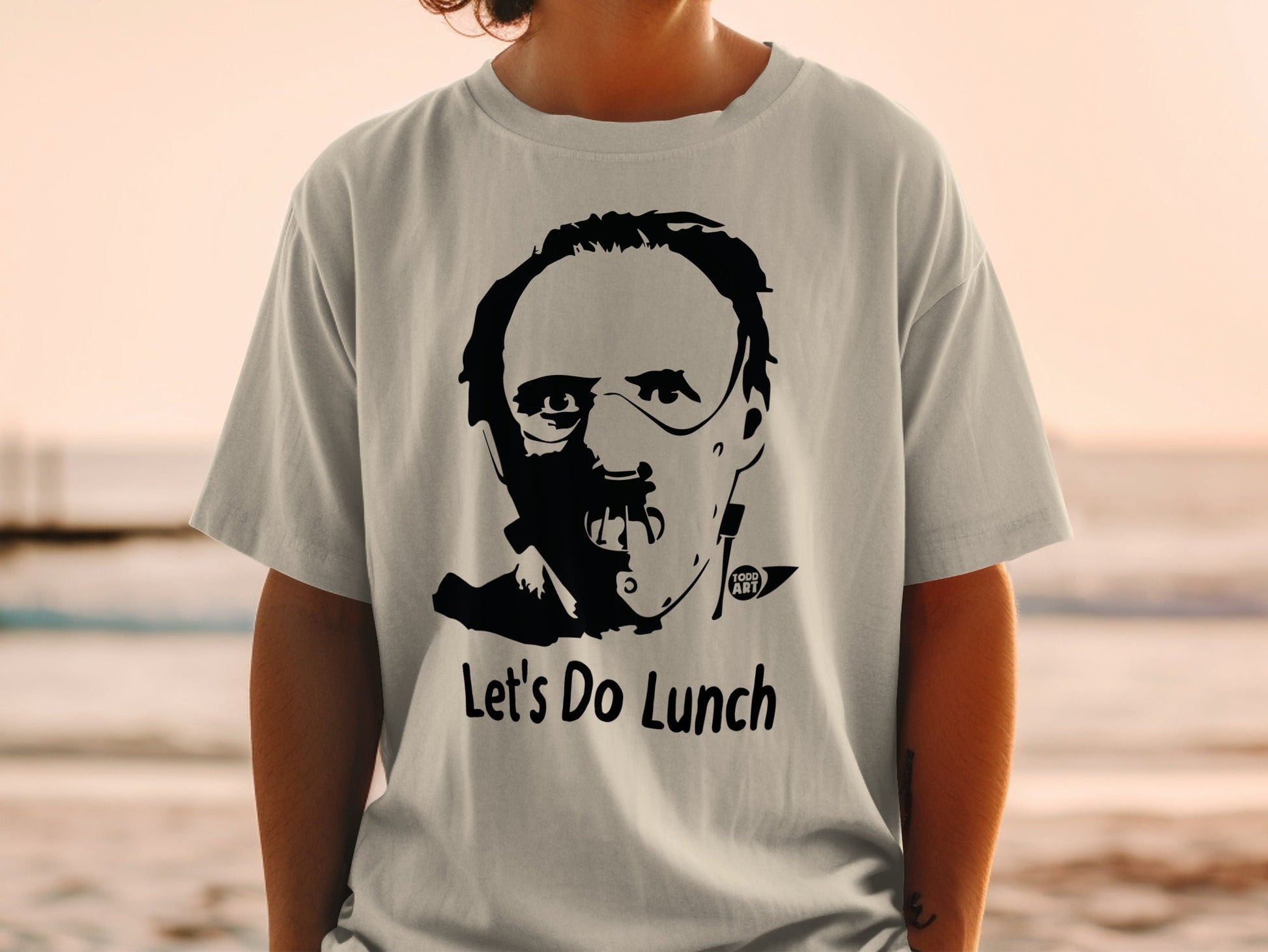 T-shirt with Hannibal Lecter mask graphic and "Let's Do Lunch" text.