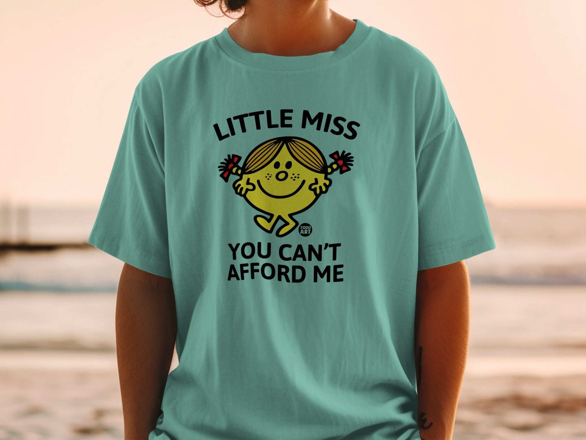Teal t-shirt with Little Miss character and text "YOU CAN'T AFFORD ME".