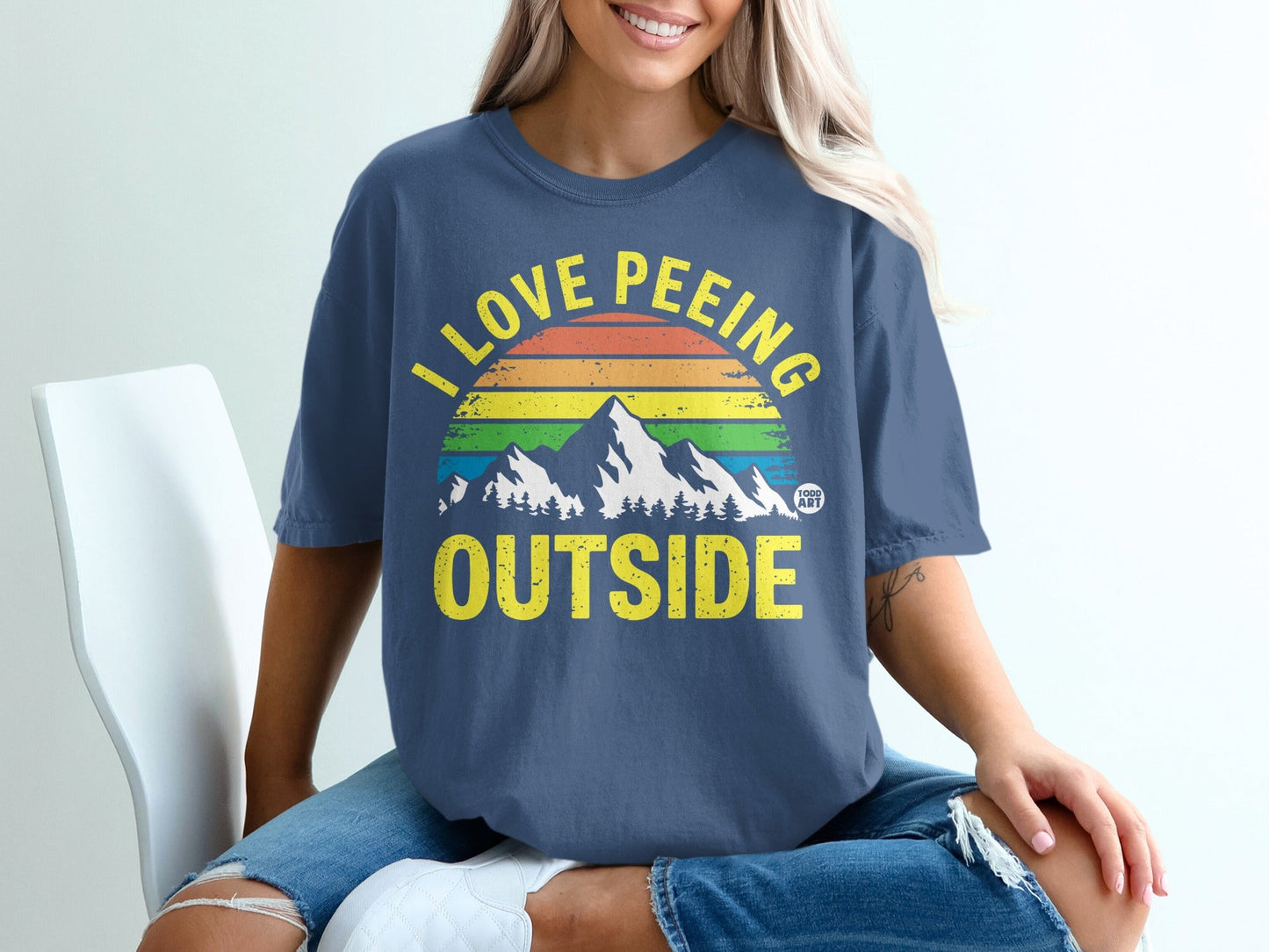 Navy t-shirt with rainbow mountains and "I LOVE PEING OUTSIDE" text.