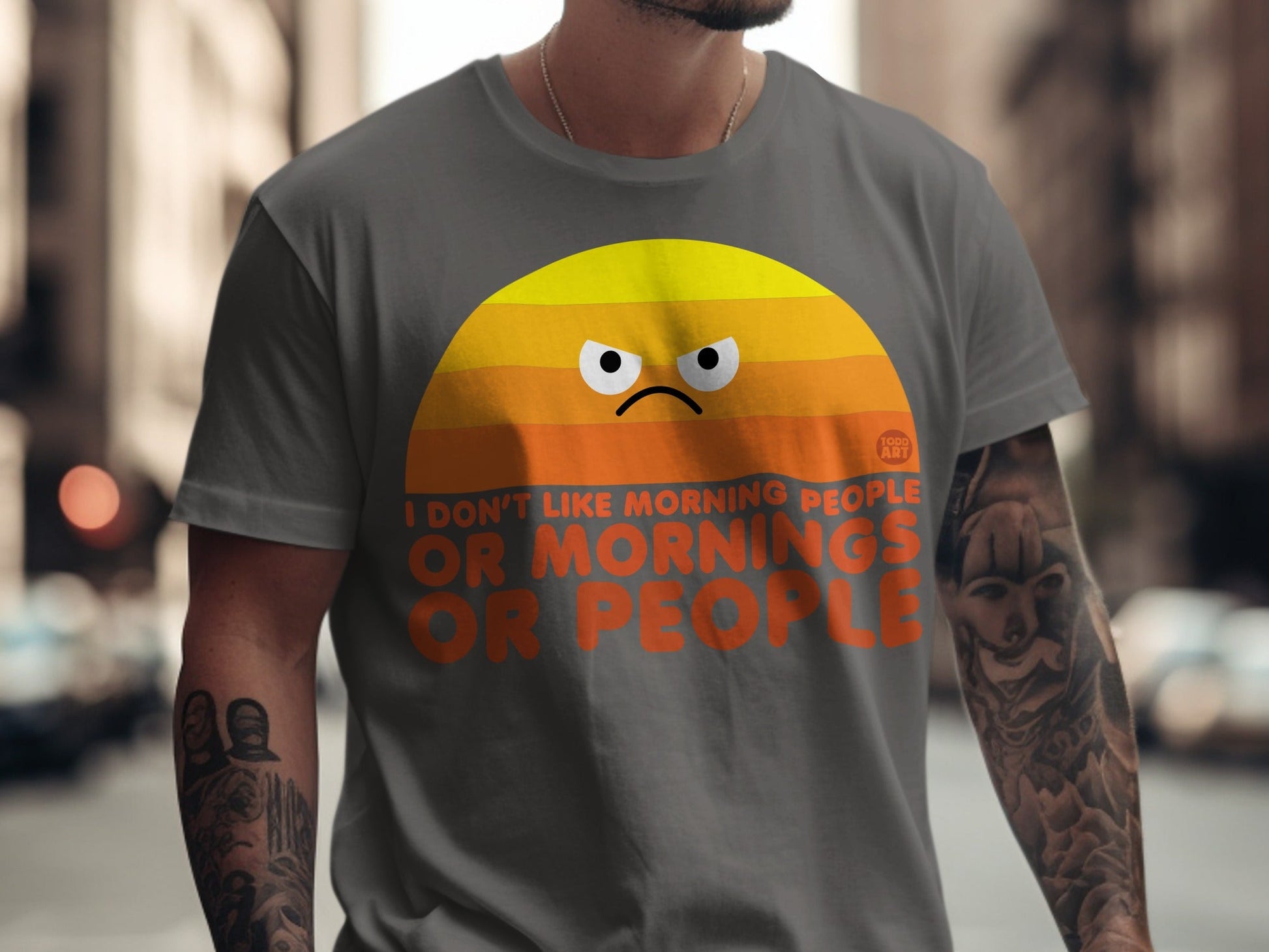 Grey t-shirt with a grumpy sunrise graphic and text "I DON'T LIKE MORNING PEOPLE OR PEOPLE".