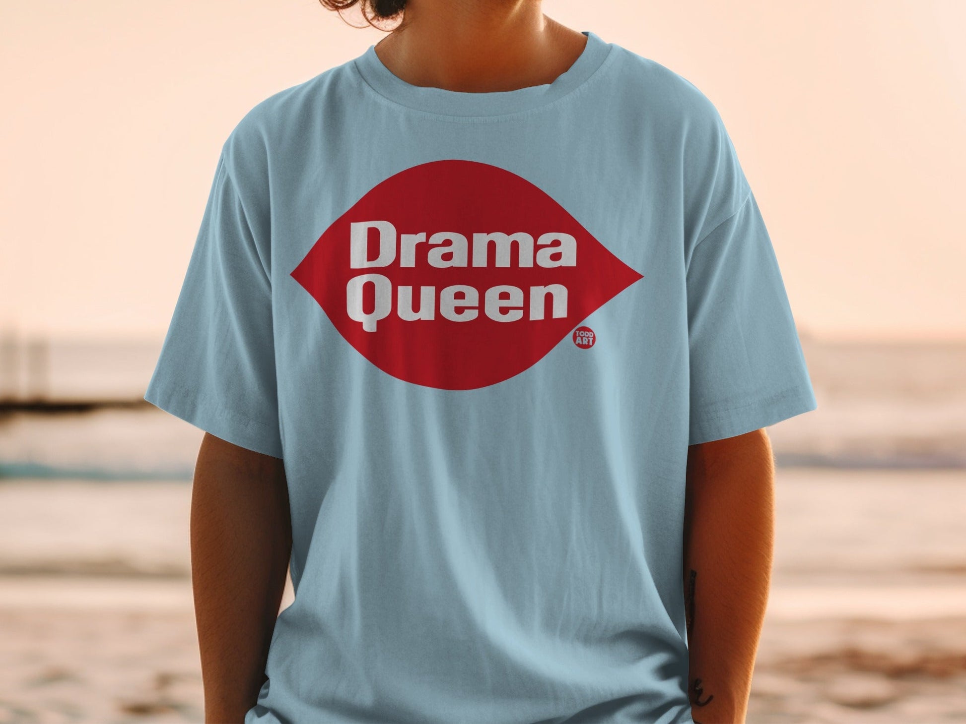 Light blue t-shirt with red "Drama Queen" text and logo.