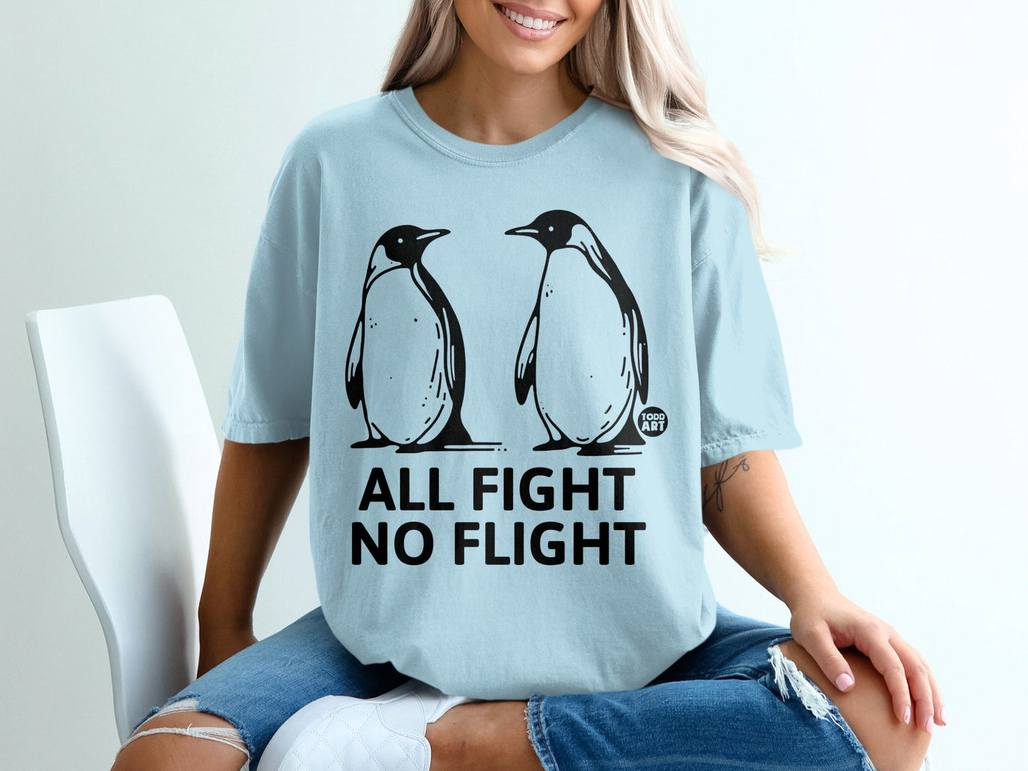 Light blue t-shirt with two penguins and text "All Fight No Flight".