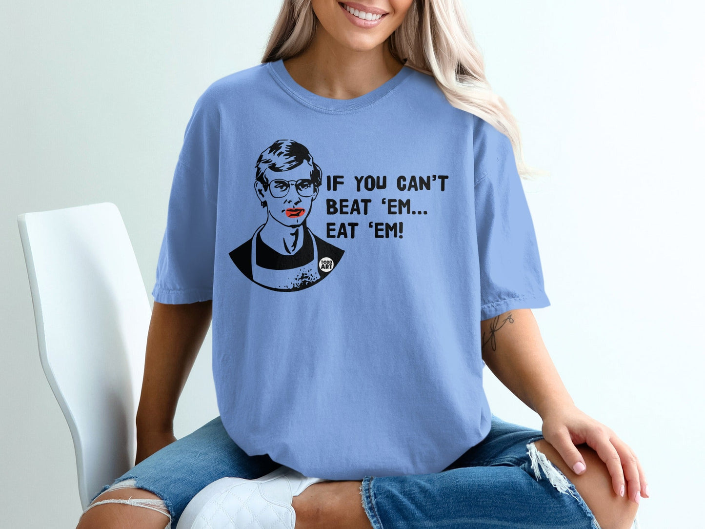Light blue t-shirt with graphic of Ruth Bader Ginsburg and text "IF YOU CAN'T BEAT 'EM! BEAT 'EM!".