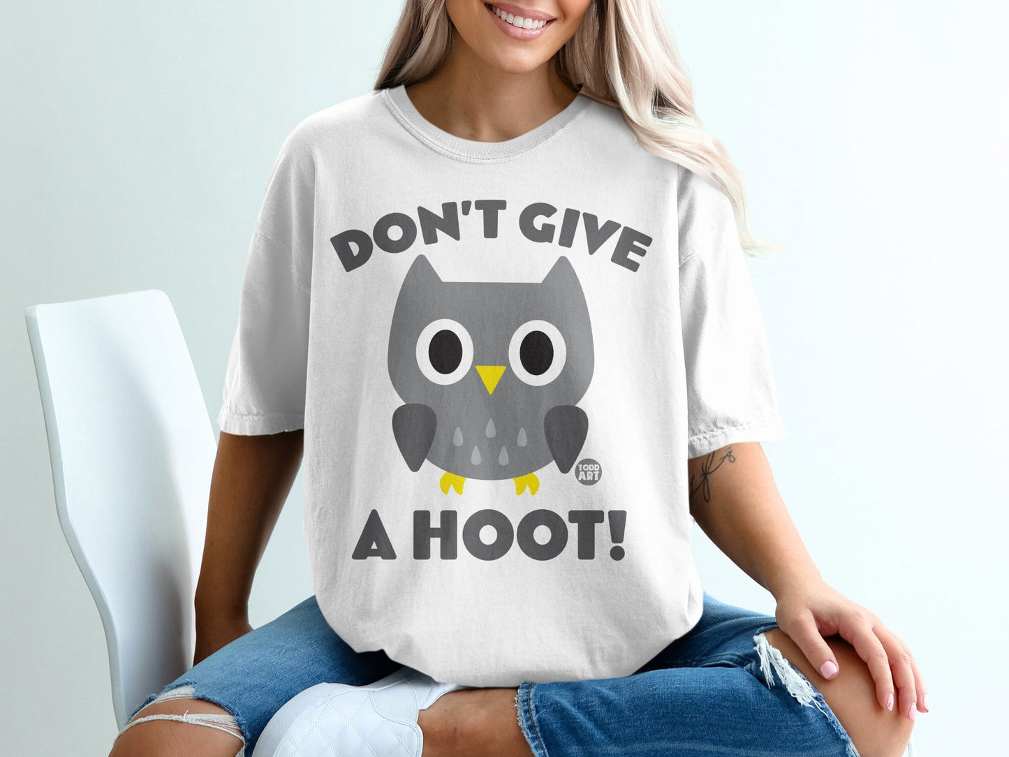 White t-shirt with a cartoon owl and text "Don't Give A Hoot!".