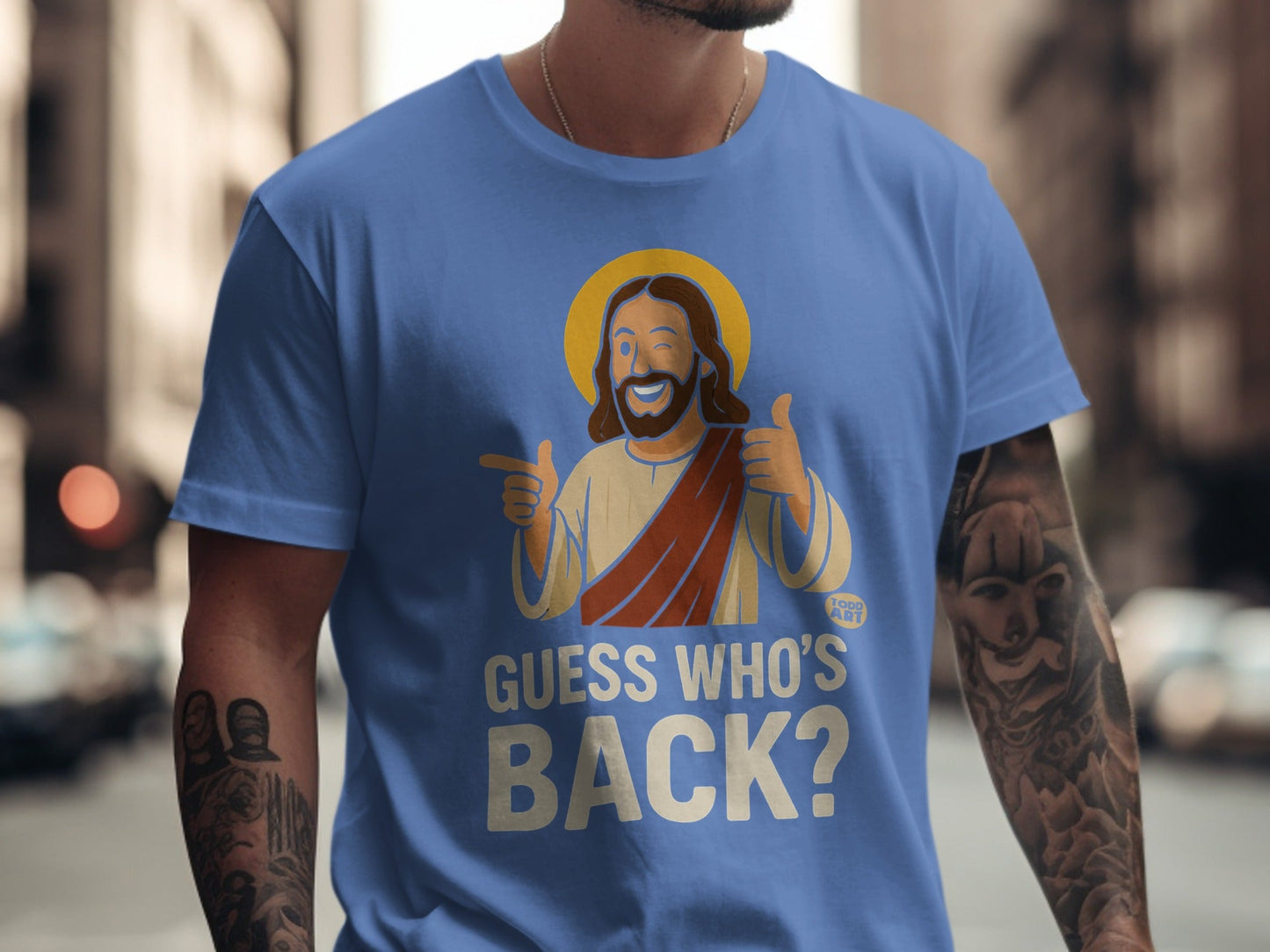 Blue t-shirt with Jesus giving thumbs up and text "GUESS WHO'S BACK?".