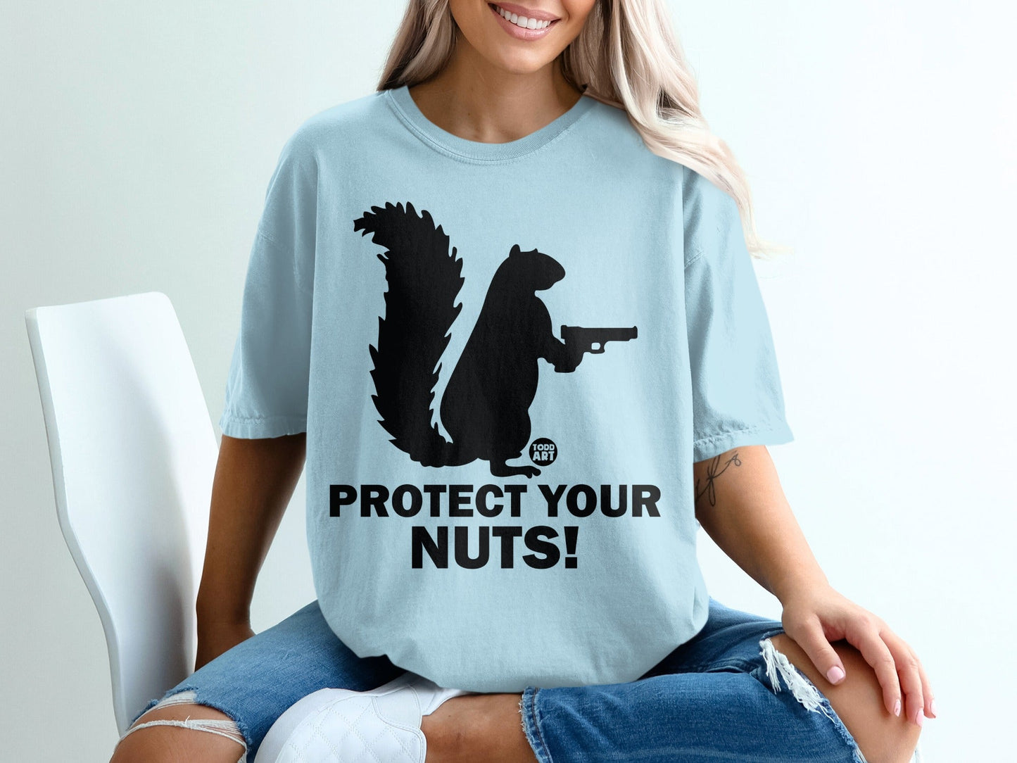 Black squirrel silhouette holding a pistol, "Protect Your Nuts" text.