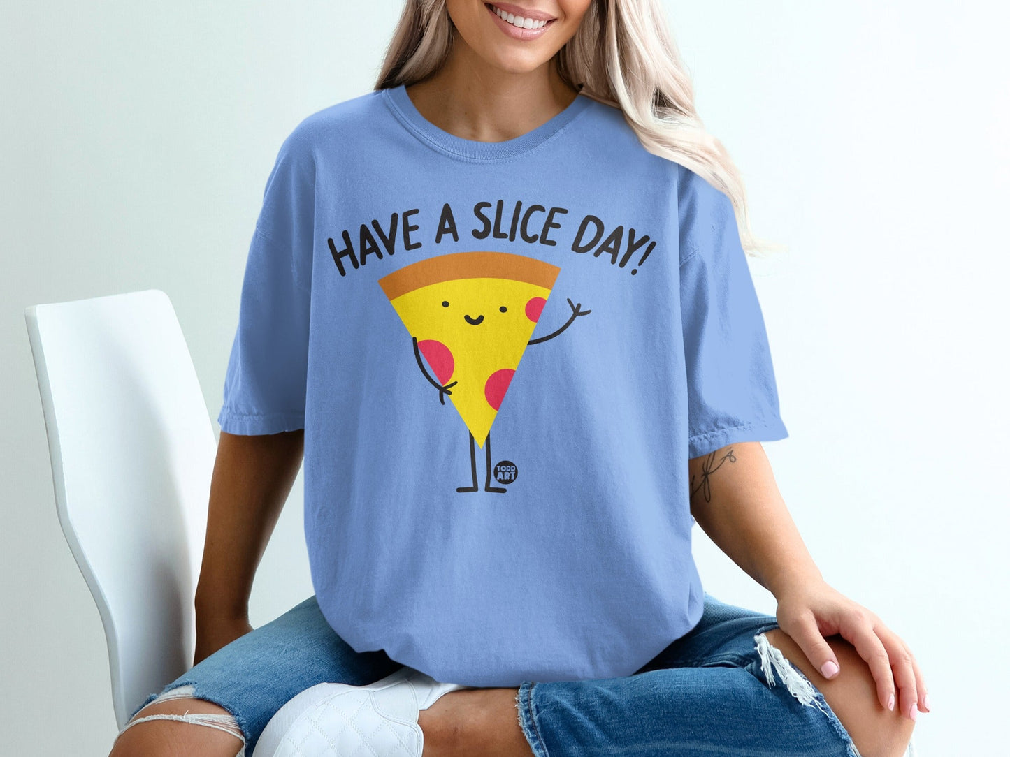 Blue t-shirt with a smiling slice of pizza saying "HAVE A SLICE DAY!".