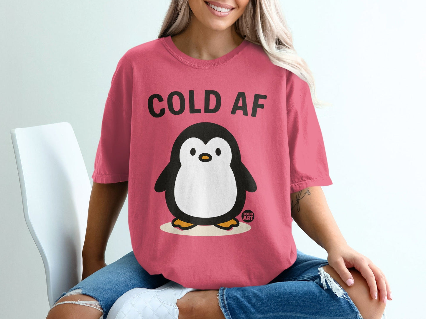 Pink t-shirt with a cartoon penguin and "COLD AF" text.