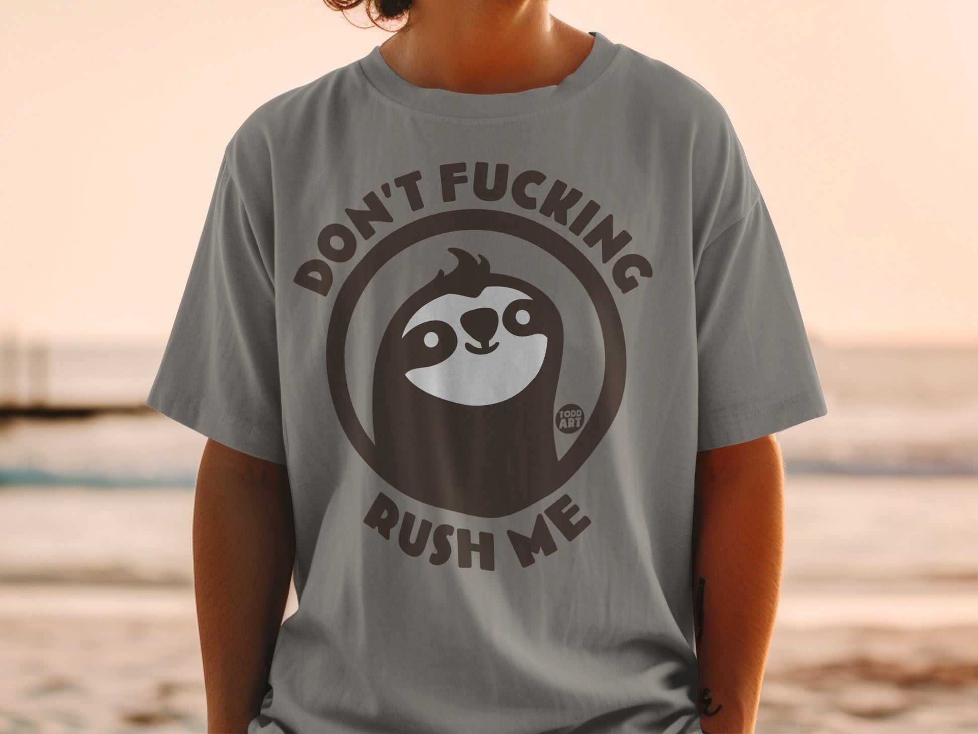 Grey t-shirt with sloth graphic and text "Don't Fucking Rush Me".