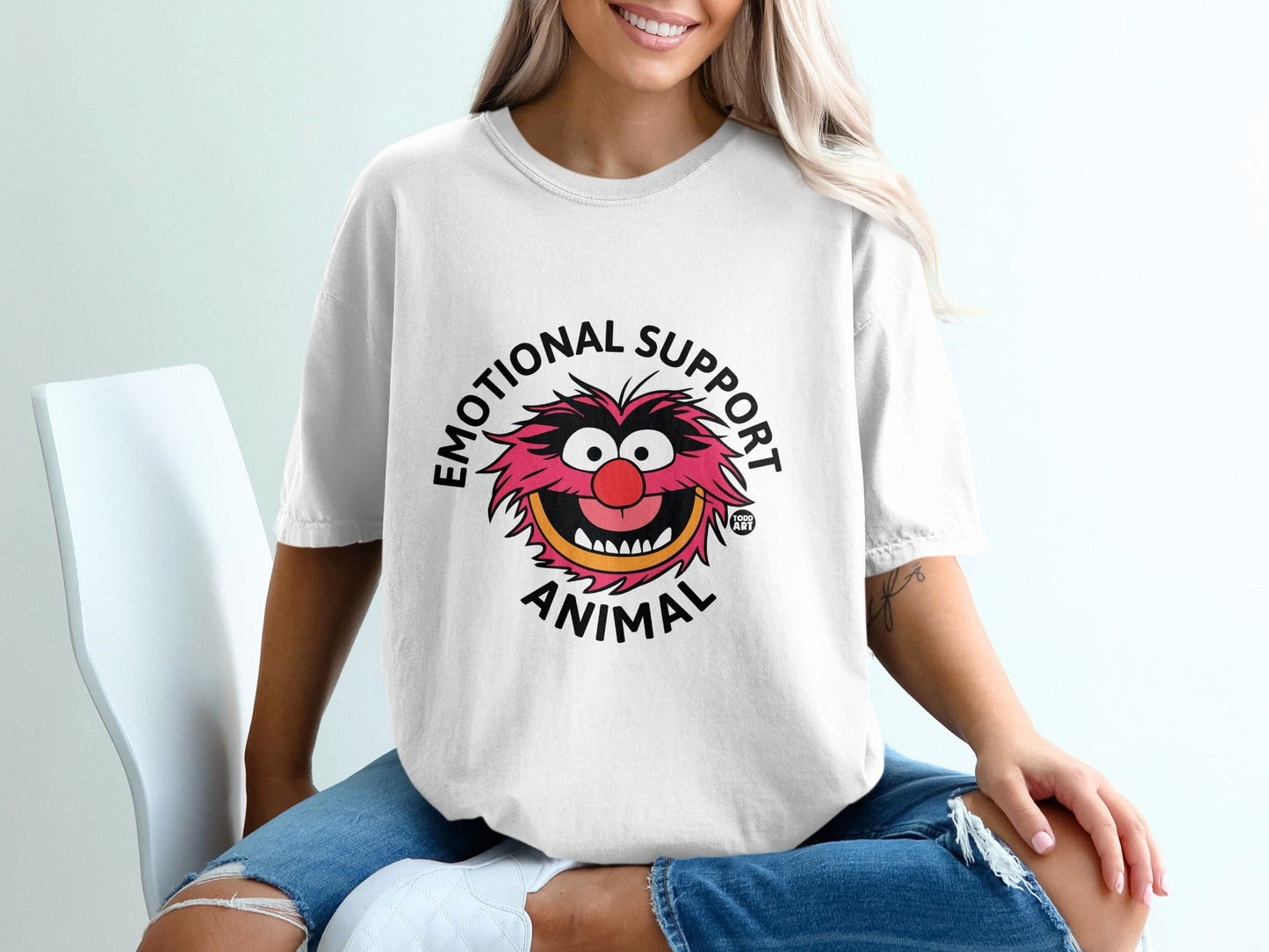 White t-shirt with "Emotional Support Animal" text and cartoon animal graphic.