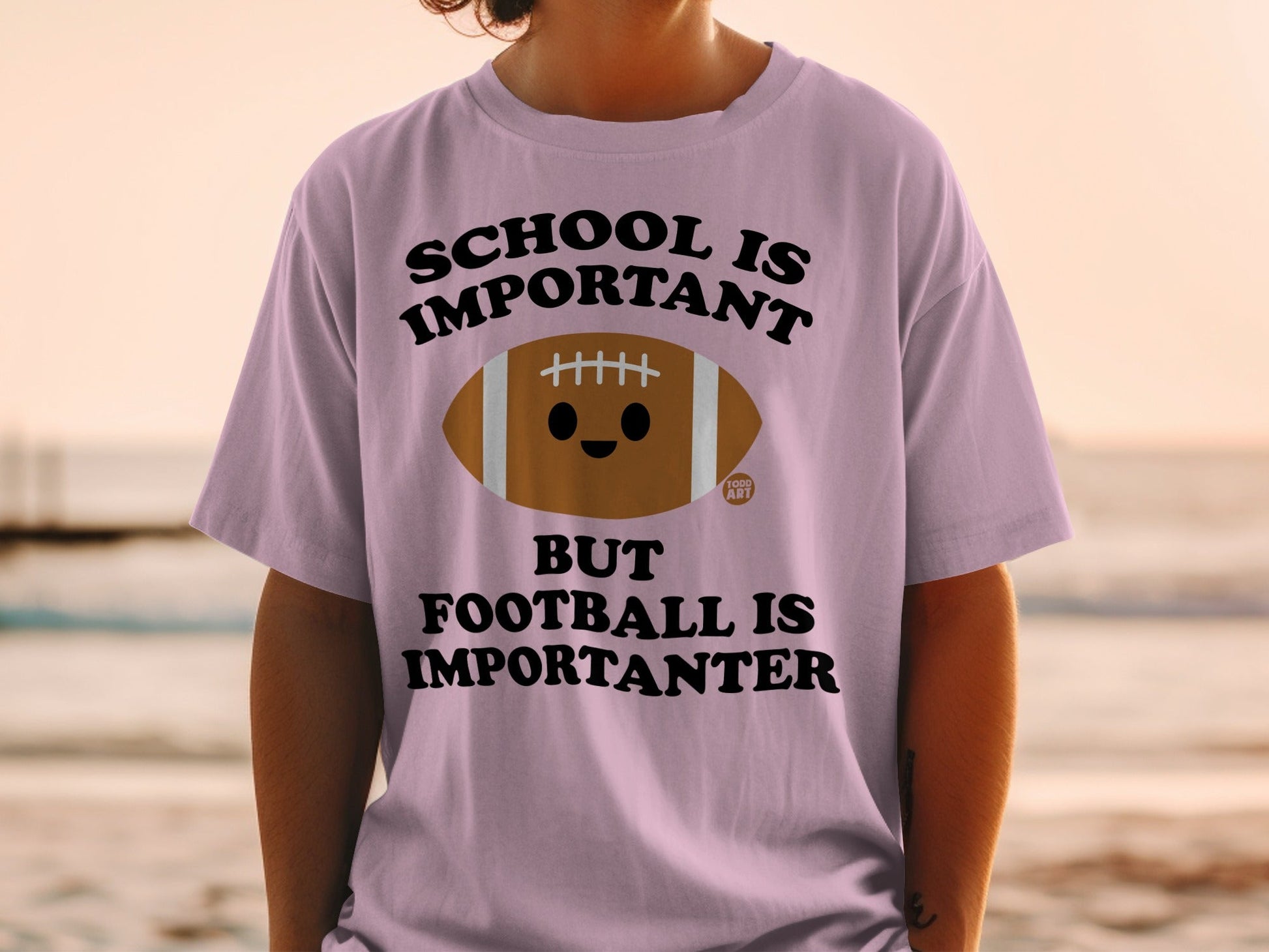 T-shirt with "School is Important but Football is Importanter" text and cartoon football.