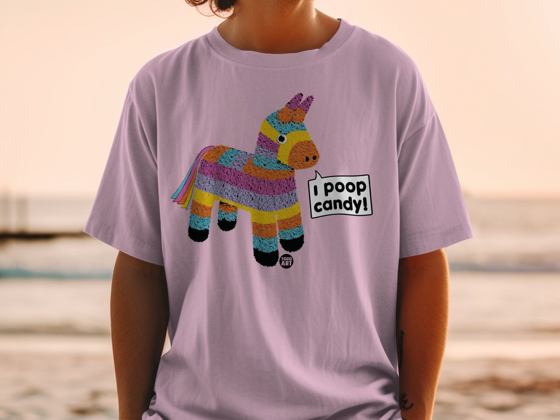 Pink t-shirt with a colorful pi√±ata graphic saying "I poop candy!".