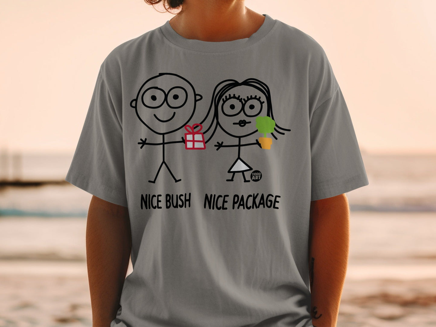 T-shirt with stick figures holding gifts, text "NICE BUSH NICE PACKAGE".