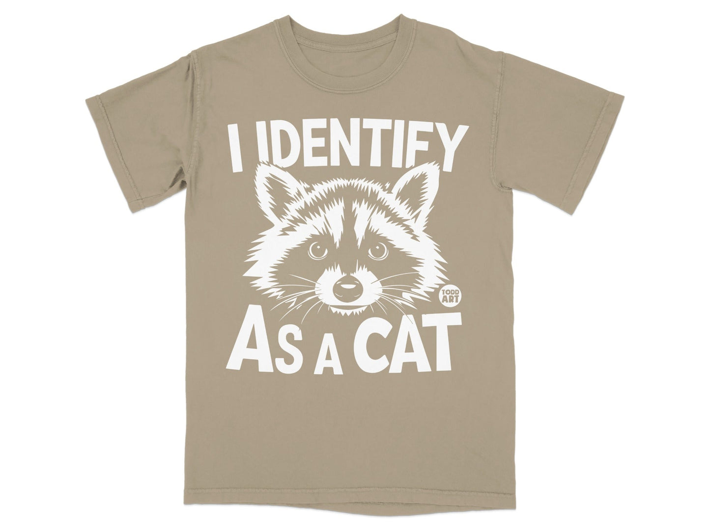 Tan t-shirt with white text "I IDENTIFY AS A CAT" and a raccoon graphic.