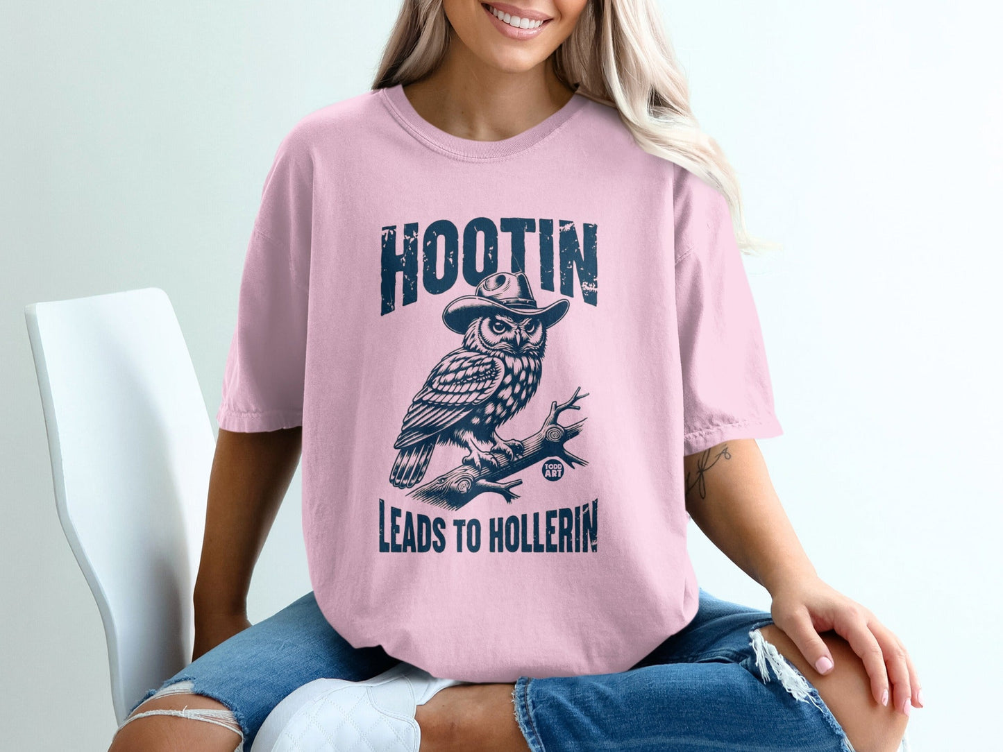Pink t-shirt with owl wearing a cowboy hat and text "HOOTIN LEADS TO HOLLERIN".