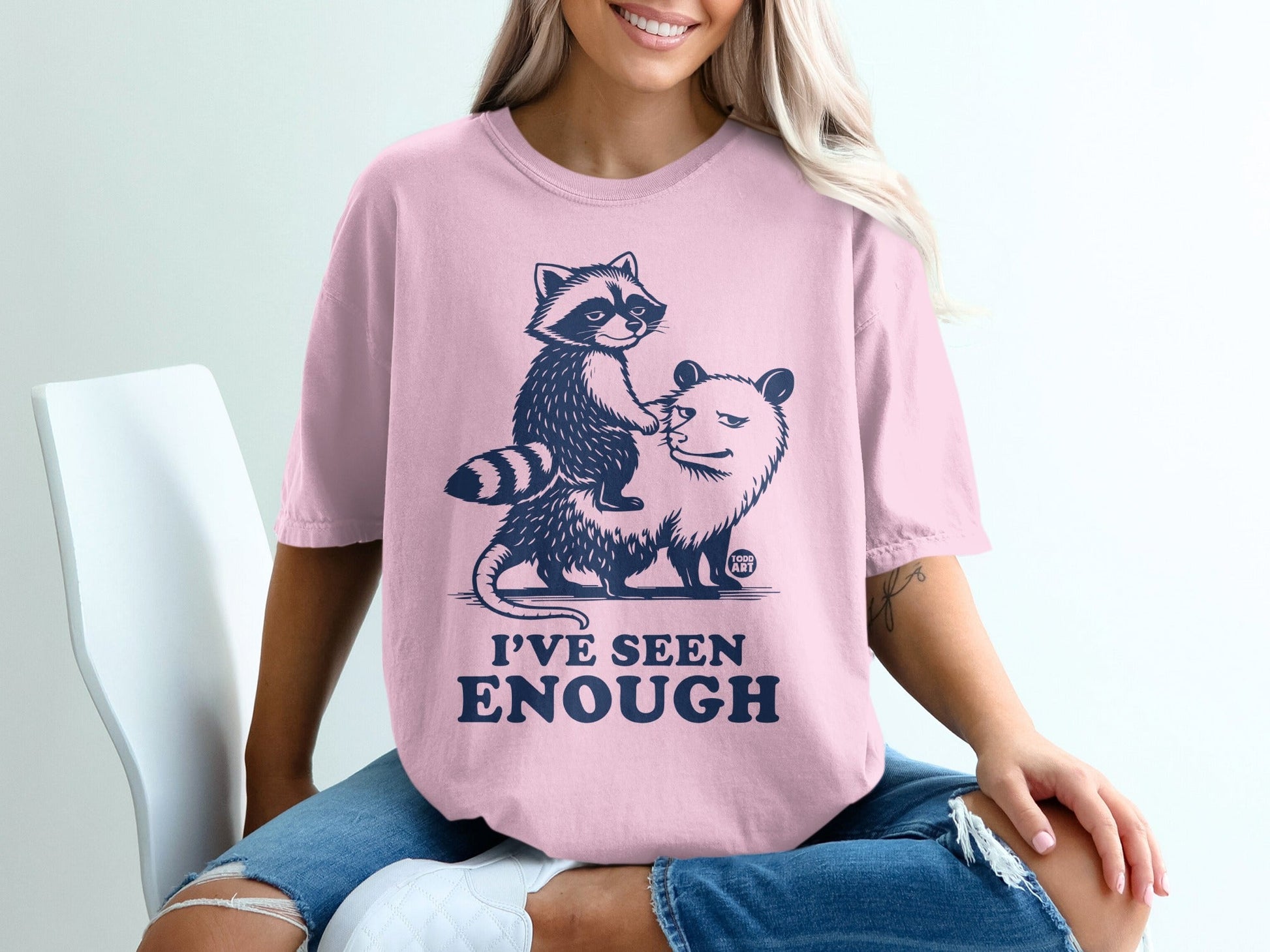 Pink t-shirt with raccoon riding an opossum, text "I'VE SEEN ENOUGH".