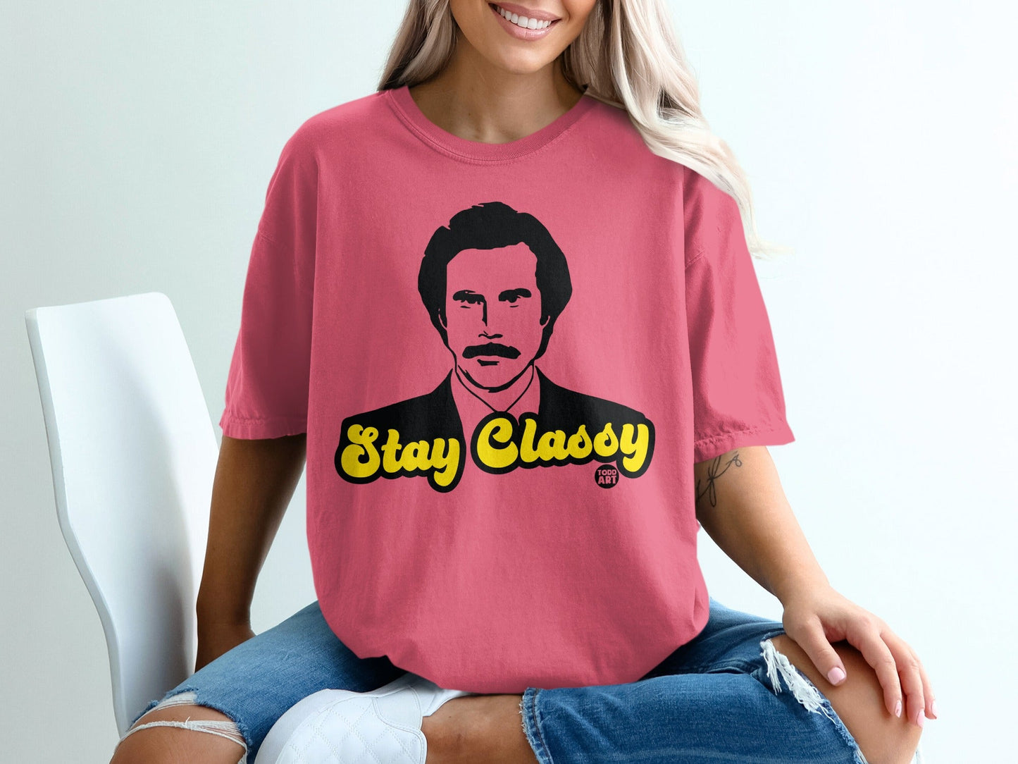 Pink t-shirt with "Stay Classy" text and a man's portrait.