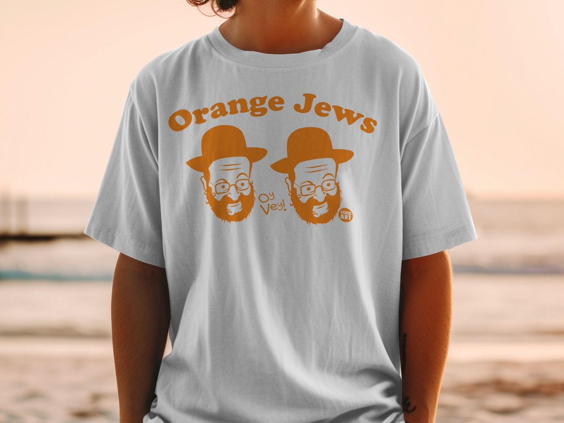 T-shirt with cartoon orange figures wearing hats and glasses, "Orange Jews Oy Vey!"