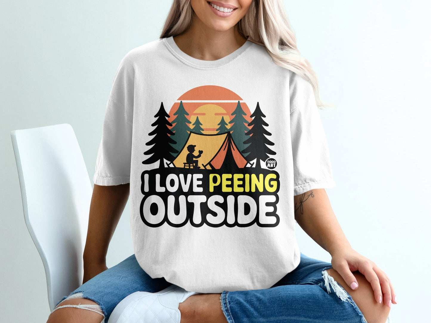 T-shirt graphic: tent, trees, sunset, text "I love peeing outside".