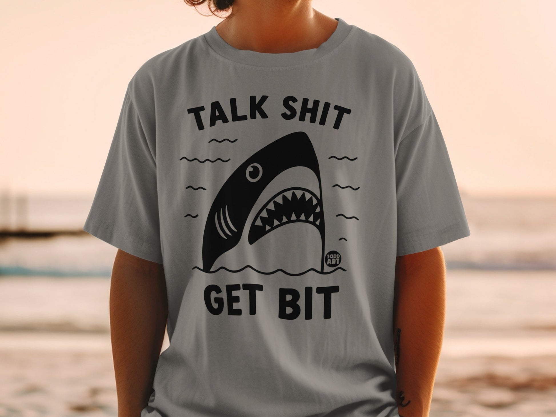 Gray t-shirt with black shark graphic and text "TALK SHIT GET BIT".