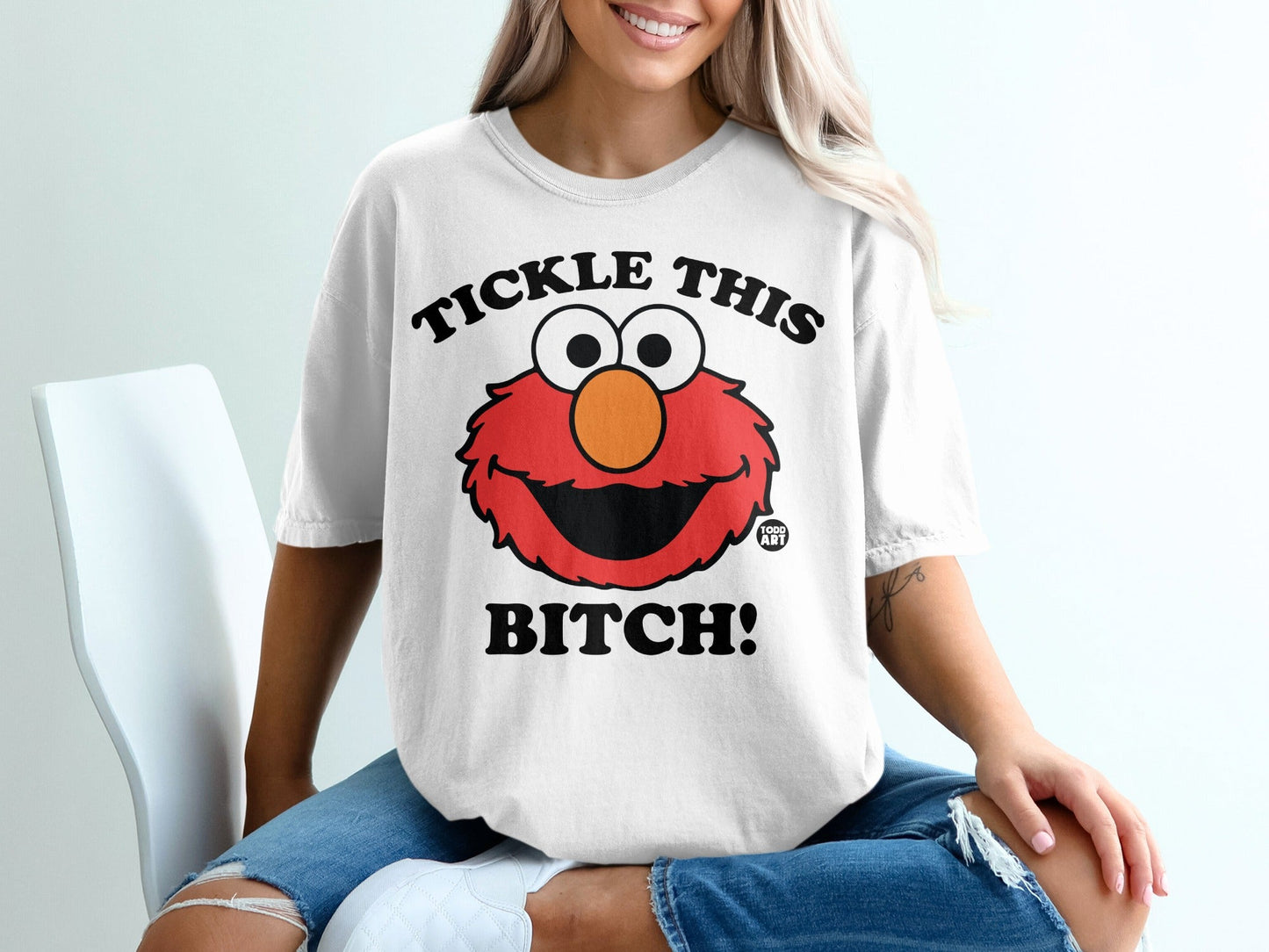 White t-shirt with Elmo saying "Tickle This Bitch!"