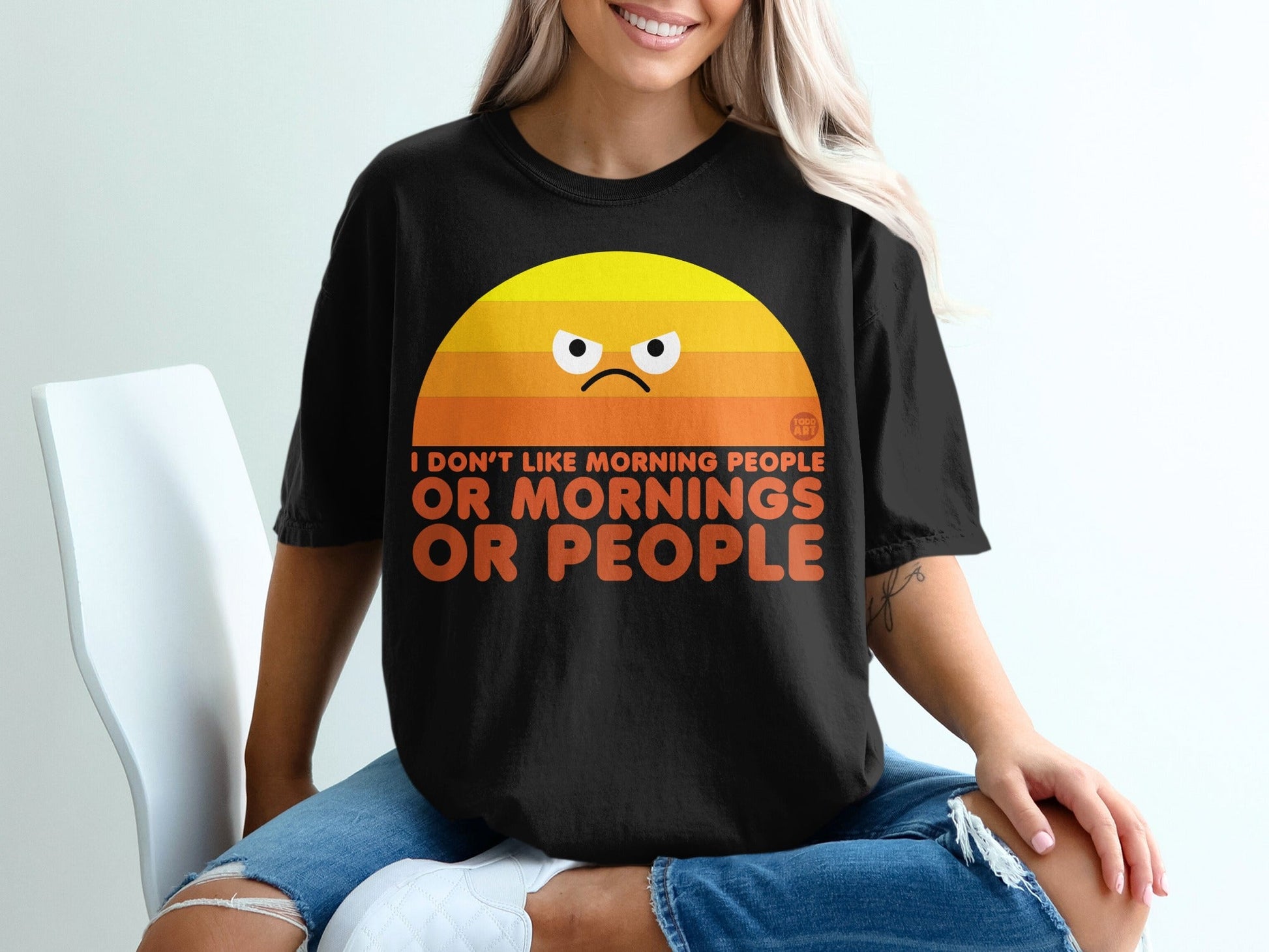 Black t-shirt with grumpy sun graphic and text "I DON'T LIKE MORNING PEOPLE OR MORNINGS".