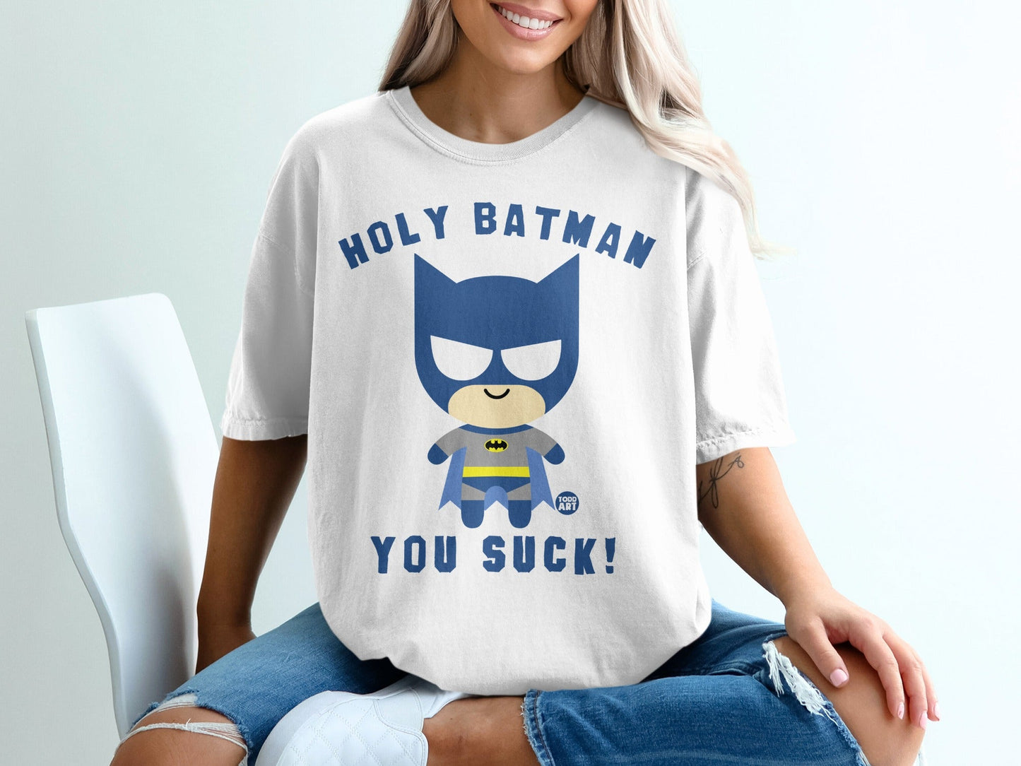 White t-shirt with "HOLY BATMAN YOU SUCK!" text and cartoon Batman graphic.