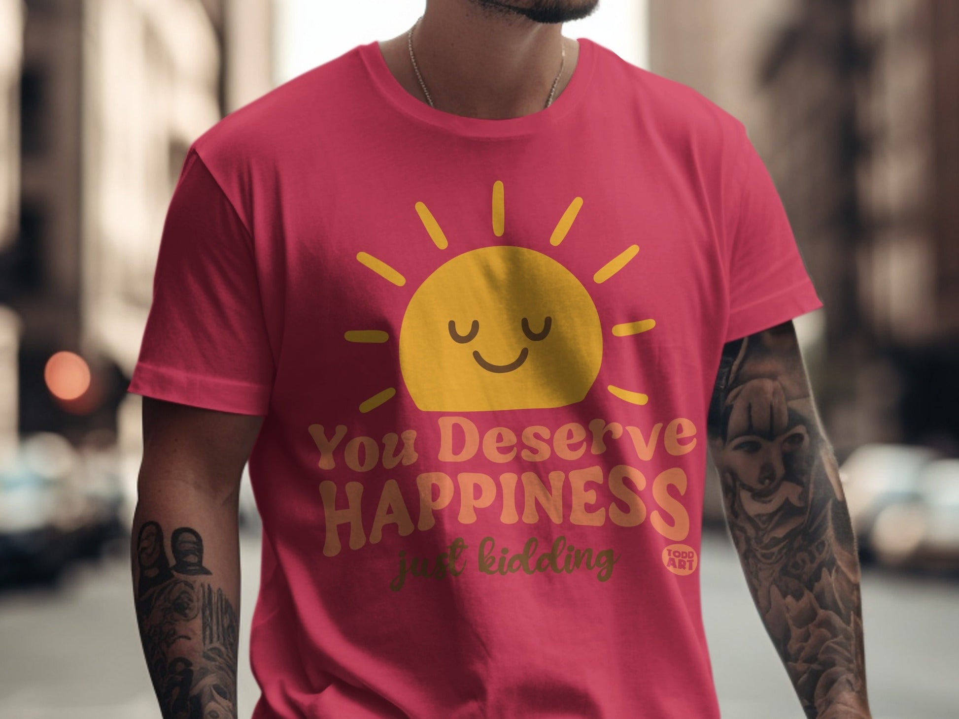 Red t-shirt with yellow sun graphic and text "You Deserve Happiness just kidding".