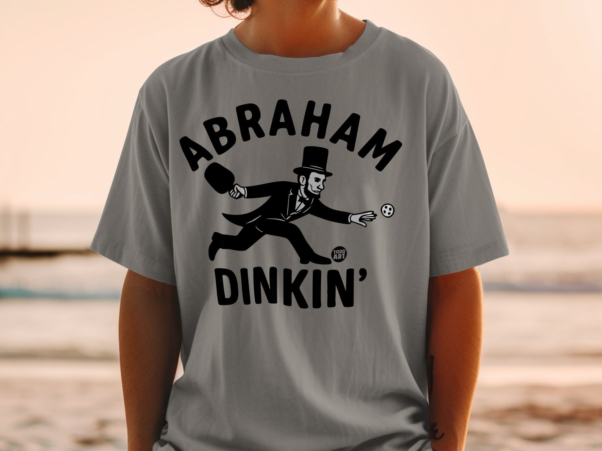 Abraham Lincoln playing pickleball in a tuxedo, wearing a hat.